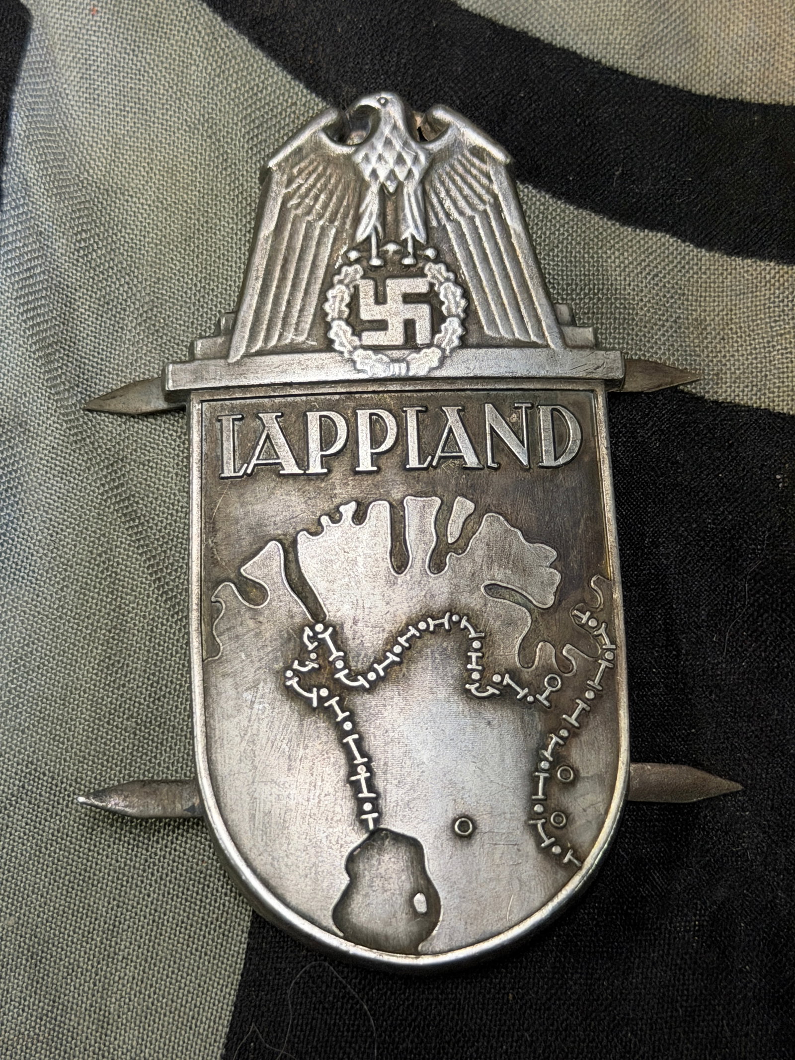 WWII German Lappland Shield Badge: WWII German Lappland Shield Badge. A rare find. The Lapland Shield (German: Lapplandschild) was a World War2 German military decoration awarded to military personnel of General Franz Bohmes 20thMounta
