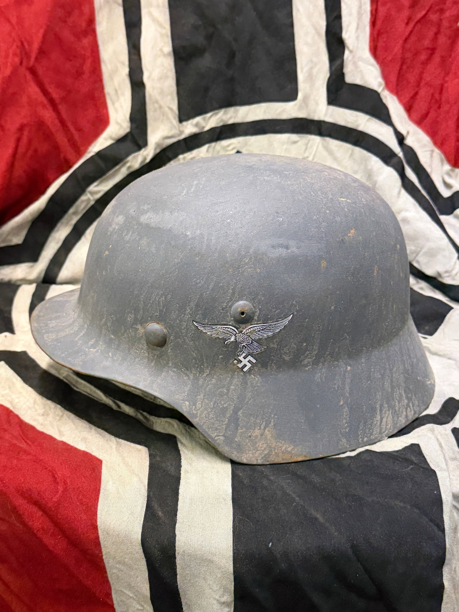WW2 German Luftwaffe Double Decal M-35 Helmet: WW2 German Luftwaffe Double Decal M-35 Helmet. The Shell is painted with a dark grey paint, The left side has the early droop tail Luftwaffe flying eagle decal. The right side has the red, white, and 