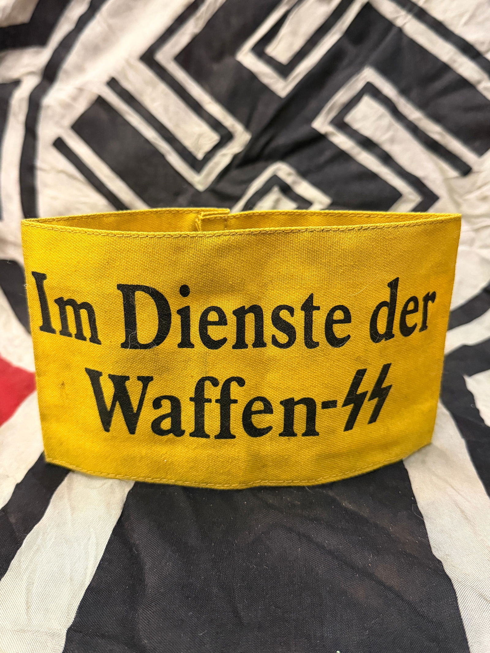 WWII German Im Dienste der Waffen SS Armband With RZM Paper Tag: WWII German Im Dienste der Waffen SS Armband With RZM Paper Tag. Introduced for wear by non-German personnel serving with the Waffen-SS, it was worn on the upper left sleeve. These were necessary to i