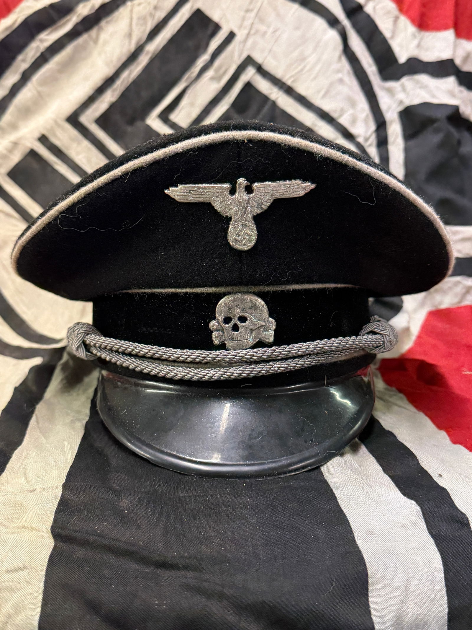 RARE WW2 GERMAN ALLGEMEINE SS OFFICER'S VISOR CAP WITH RZM PAPER TAG: RARE WW2 GERMAN ALLGEMEINE SS OFFICER'S VISOR CAP WITH RZM PAPER TAG. A VERY RARE EXAMPLE THAT IS IN MINT OVERALL SHAPE AND CONDITION WITH A BEAUTIFUL OVERALL PATINA. SHOWS GOOD WEAR AND USE. PLEASE V