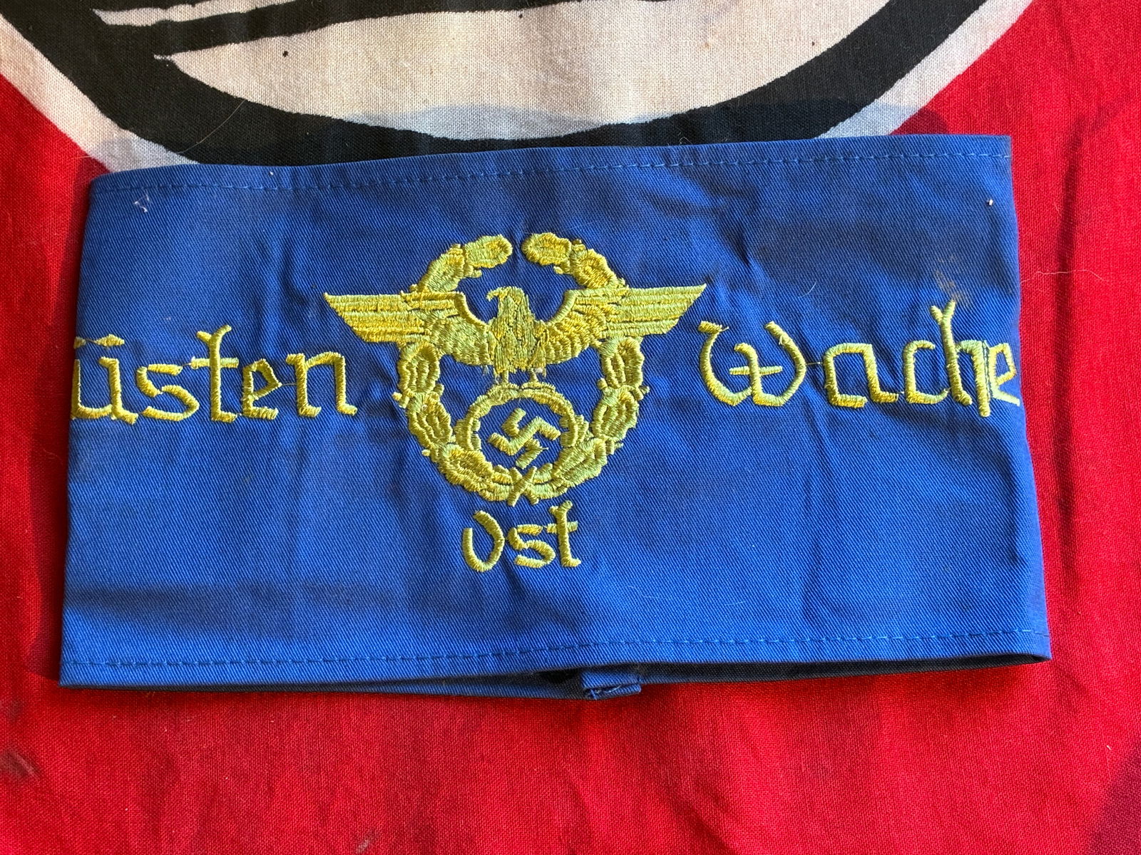 A Rare WW2 German East District Coastal Watch Police (Danzig/Prussia) Armband: A Rare WW2 German East District Coastal Watch Police (Danzig/Prussia) Armband. With dark yellow embroidered insignia on a blue cotton base, illustrating the Police insignia in the centre, inscribed "K