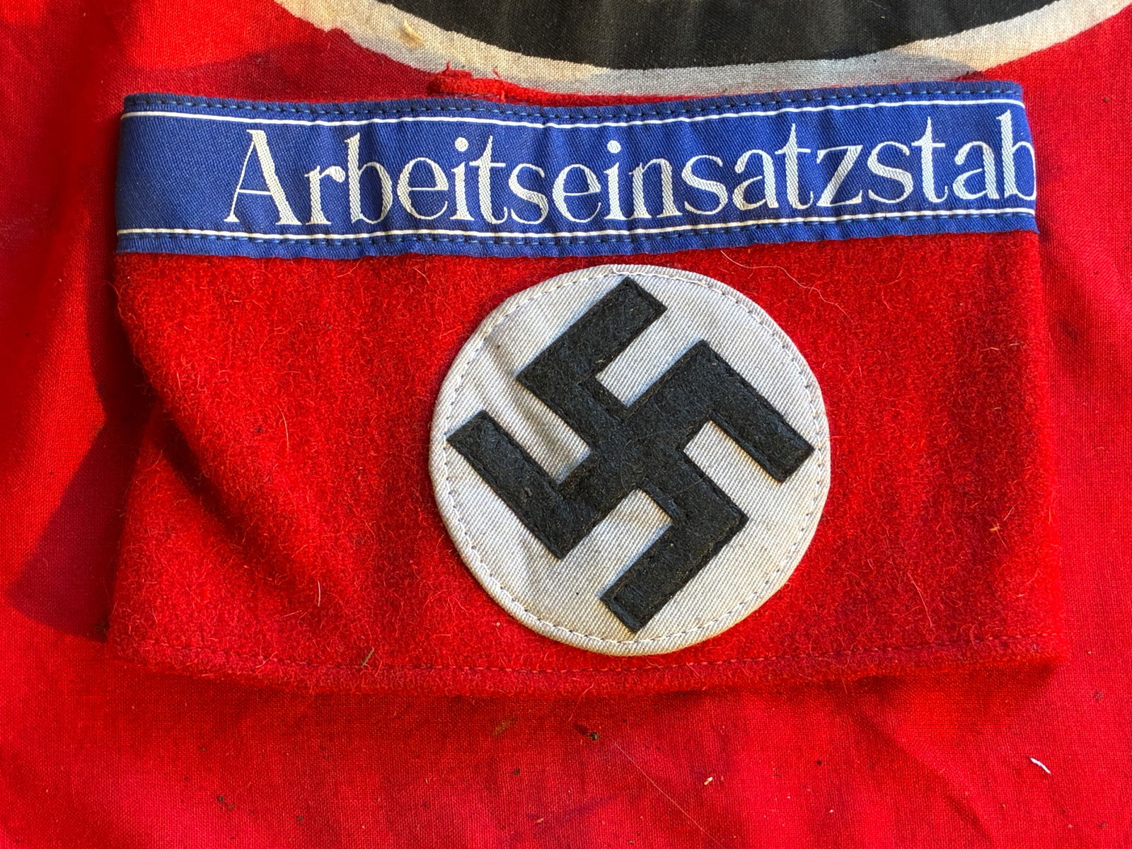 WW2 GERMAN ARBEITSEINSATZSTAB NSDAP ARMBAND WITH RZM PAPER TAG: WW2 GERMAN ARBEITSEINSATZSTAB NSDAP ARMBAND WITH RZM PAPER TAG. A RARE FIND. SHOWS GOOD WEAR AND USE WITH A BEAUTIFUL OVERALL PATINA. HAS THE RZM PAPER TAG ATTACHED ON THE INSIDE. PLEASE VIEW ALL DETA