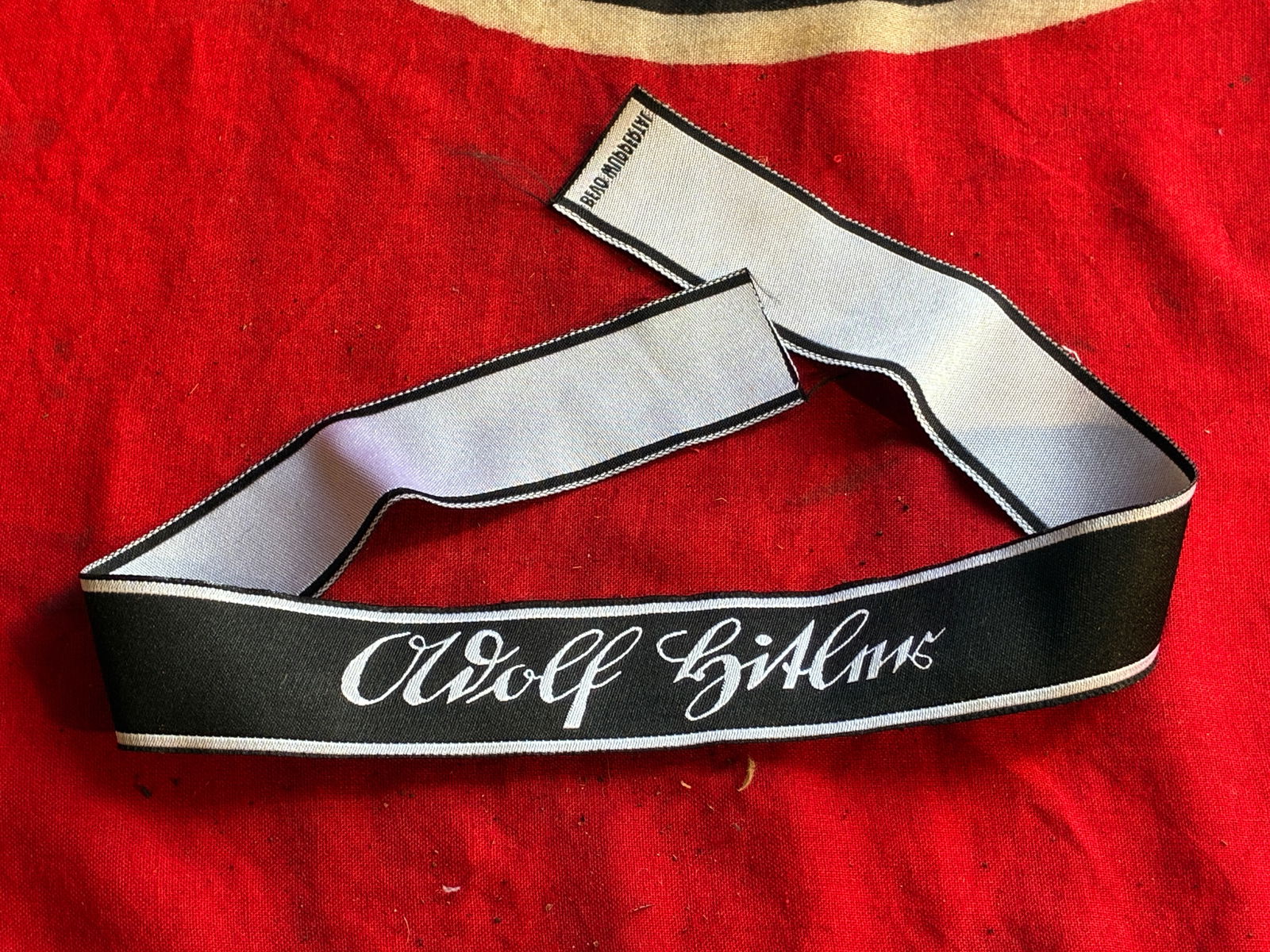 GERMAN WWII WAFFEN SS LSSAH ADOLF HITLER BEVO CUFF TITLE: GERMAN WWII WAFFEN SS LSSAH ADOLF HITLER BEVO CUFF TITLE. A German WWII type Waffen SS Panzer Division Leibstandarte Adolf Hitler Cuff Title. The item features silver wire bullion embroidery on a blac