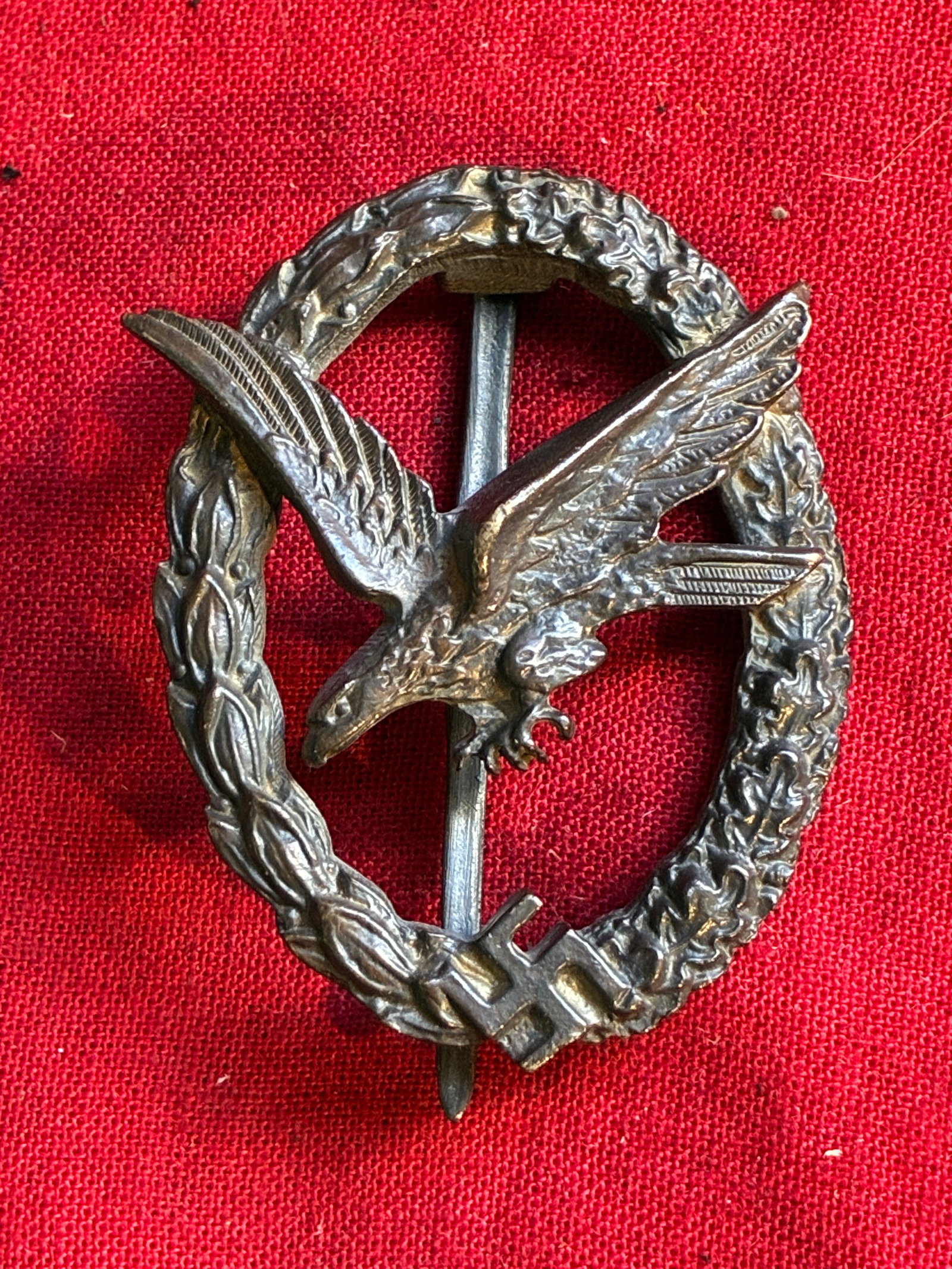 A GERMAN WWII LUFTWAFFE PARATROOPER BADGE BY JMME: A GERMAN WWII LUFTWAFFE PARATROOPER BADGE BY JMME. This is a WWII German Army Paratrooper Badge. It has a diving eagle at the center surrounded by a laurel and oak leaves wreath. The wreath has the Na