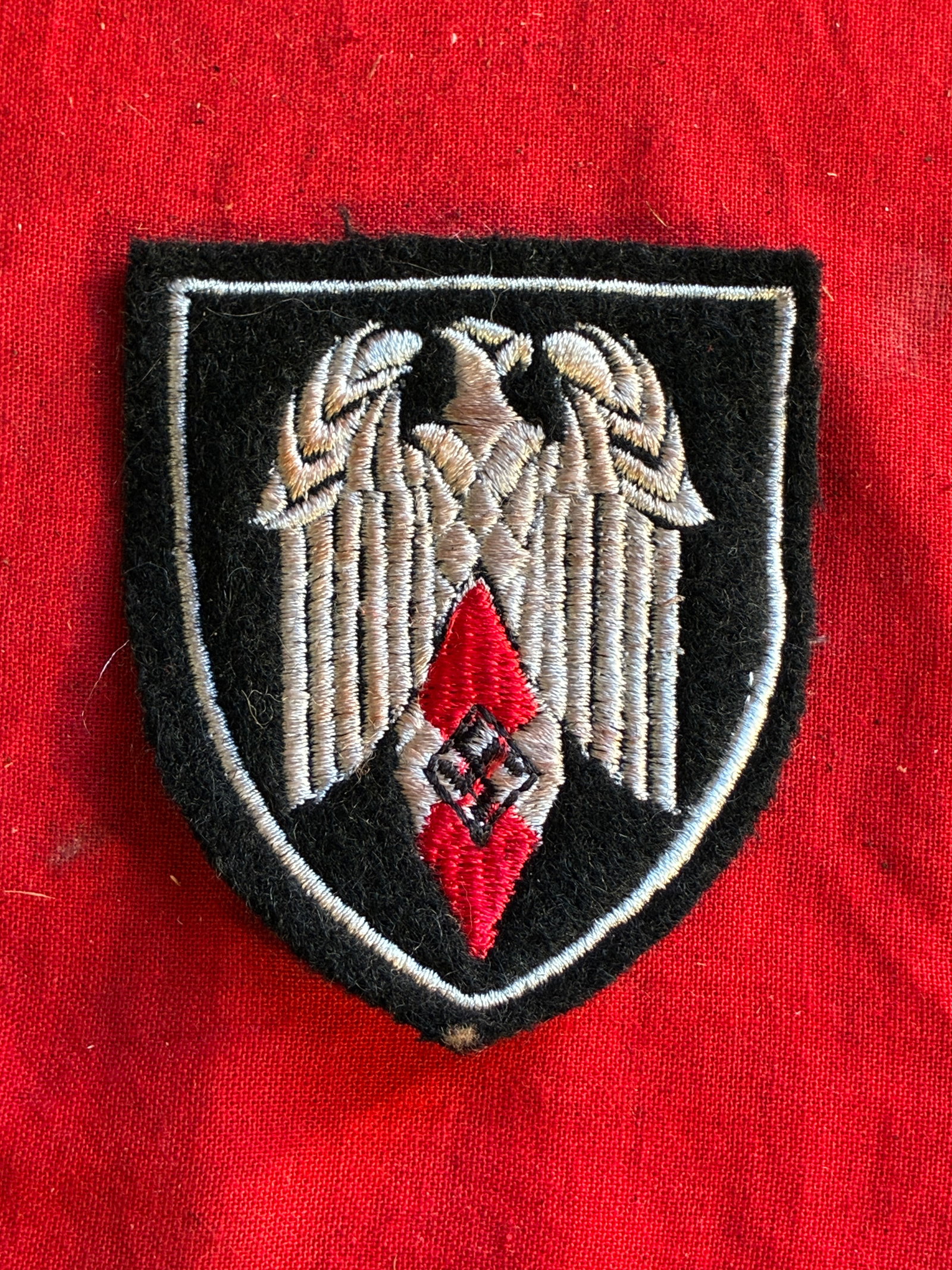 WW2 German Hitler Youth Standard Bearers sleeve insignia (red): WW2 German Hitler Youth Standard Bearers sleeve insignia (red). Shows good wear and use with a beautiful overall patina. Please view all detailed pictures. A rare example of the time period.