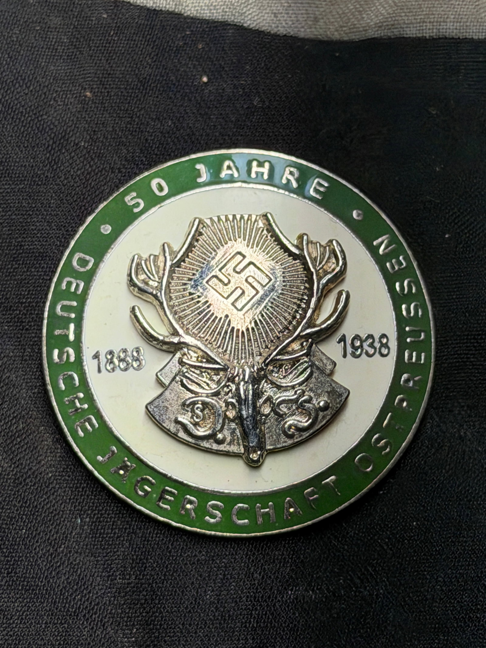 WWII GERMAN THIRD REICH 50 YEAR HUNTING DJ BADGE - UNMARKED: WWII GERMAN THIRD REICH 50 YEAR HUNTING DJ BADGE - UNMARKED. German WWII 50 Year 1888 1938 Hunting Deutsche Jagerschaft DJ Badge. Measures 1 9/16 in diameter. The front reads 1888 1938 50 Jahre Deutsc