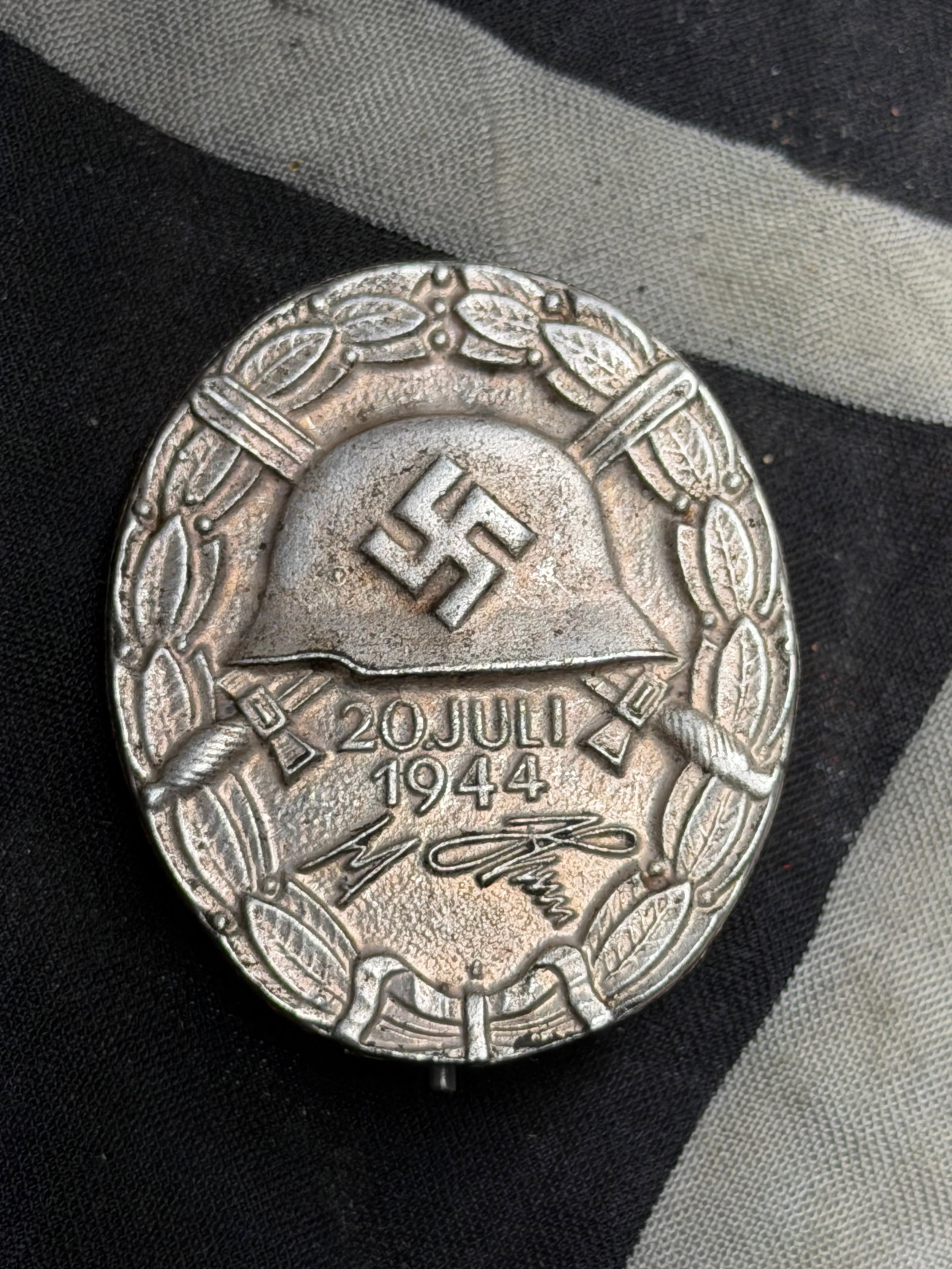 WWII GERMAN THIRD REICH SILVER WOUND BADGE MARKED 30 ADOLF HITLER SIGNATURE 20.JULI 1944: WWII GERMAN THIRD REICH SILVER WOUND BADGE MARKED 30 ADOLF HITLER SIGNATURE 20.JULI 1944. A VERY RARE EXAMPLE. MARKED 30 ON THE REVERSE. SHOWS GOOD WEAR AND USE WITH A BEAUTIFUL OVERALL PATINA. PLEASE