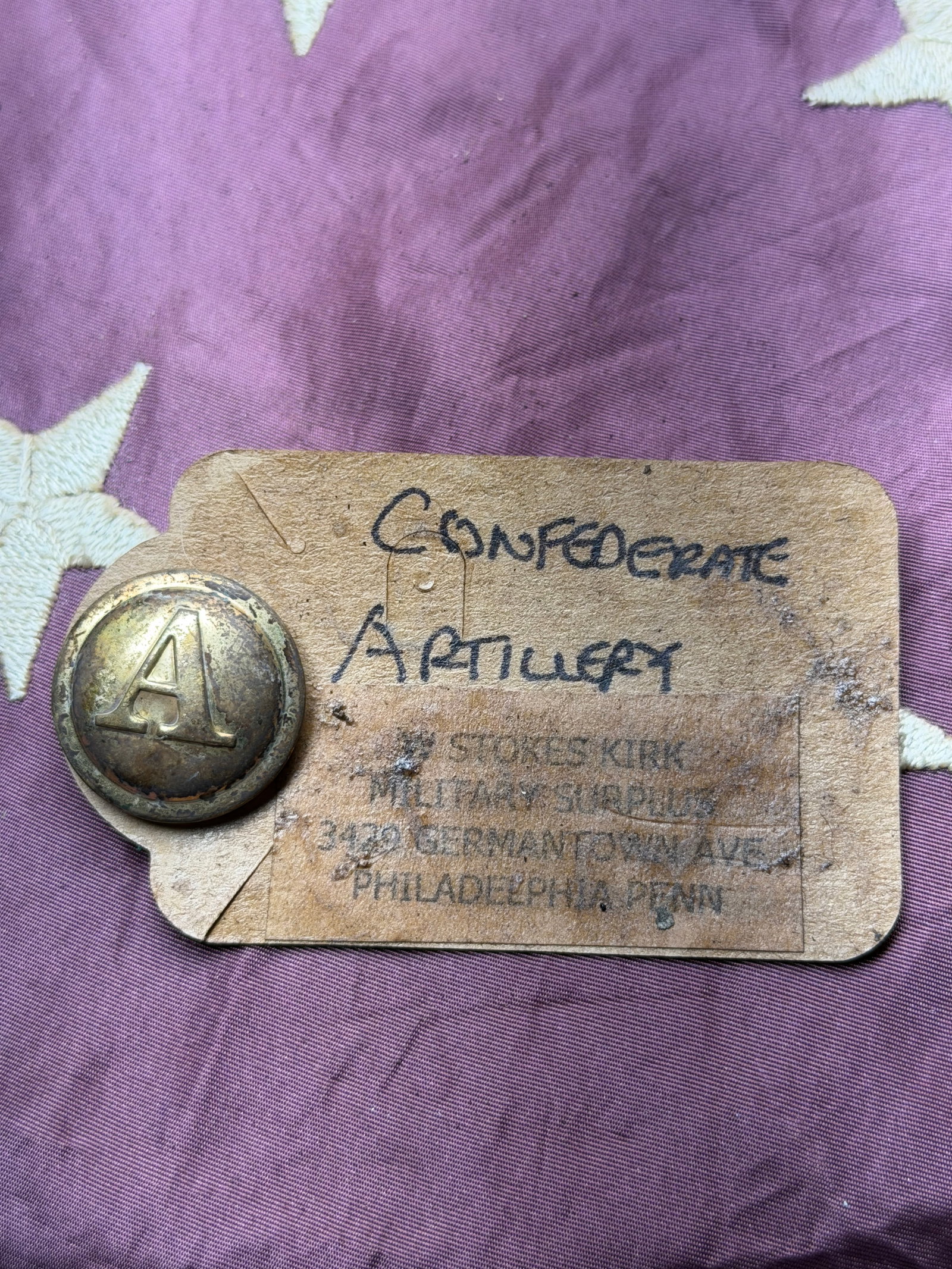 CIVIL WAR CONFEDERATE ARTILLERY BUTTON BY W. STOKES KIRK: CIVIL WAR CONFEDERATE ARTILLERY BADGE BY W. STOKES KIRK. This item is described as a uniform button, coat-size typically around 22–23 mm diameter), bearing the branch insignia for artillery in the C