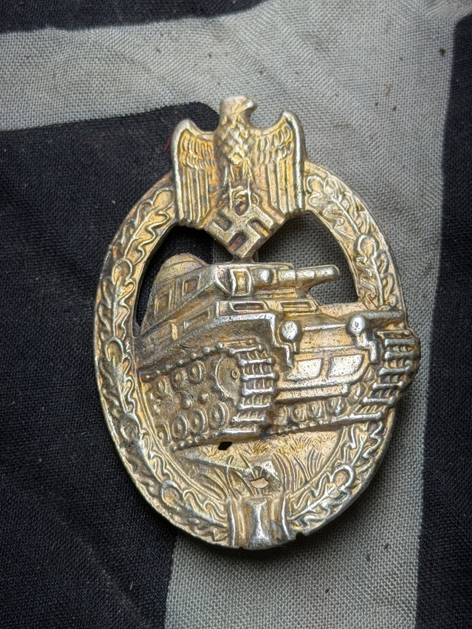 German WWII Silver Grade Panzer Assault Tank Badge - Scoop Back Version: German WWII Silver Grade Panzer Assault Tank Badge - Scoop Back Version. A very rare example. Shows good wear and use with a beautiful overall paitna. The Panzer Badge (German: Panzerkampfabzeichen) w