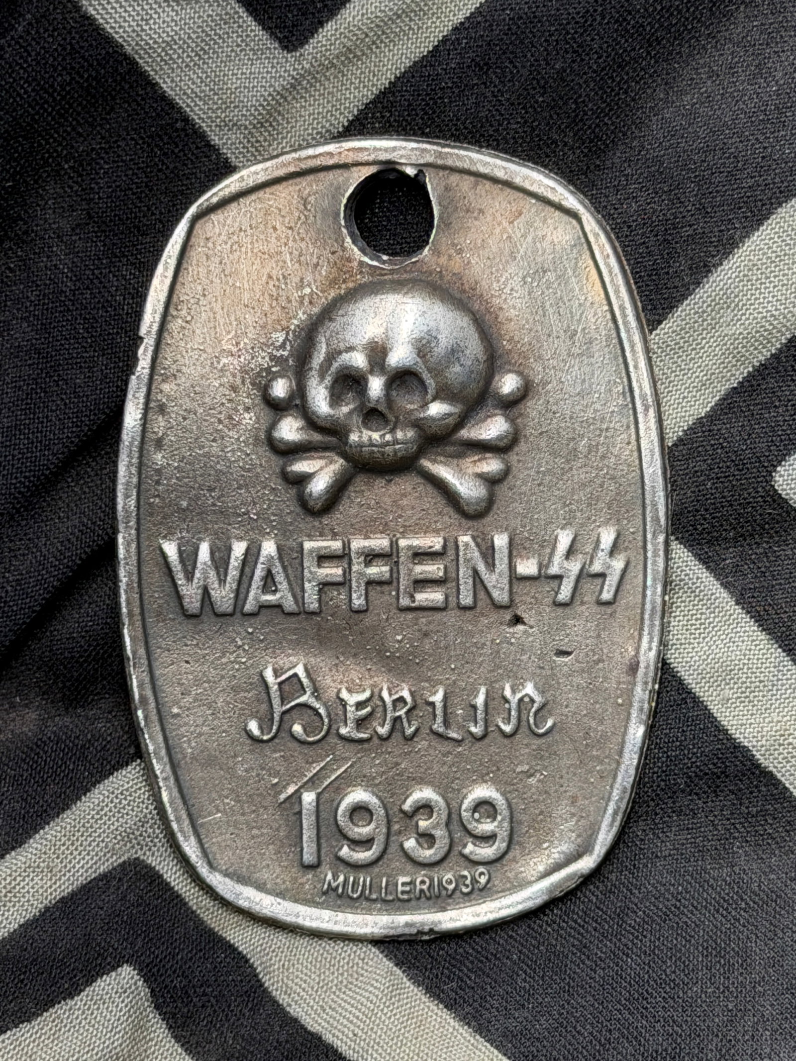 WW2 German Waffen SS ID tag Berlin: WW2 German Waffen SS ID tag Berlin. Shows good wear and use with a beautiful overall patina. Please view all detailed pictures. A rare example of the time period.