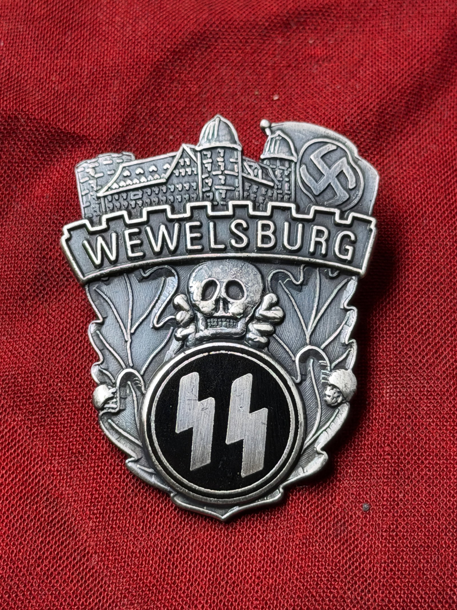 GERMAN WWII SS WEWELSBURG ACADEMY BADGE BY GES. GESCH.: GERMAN WWII SS WEWELSBURG ACADEMY BADGE BY GES. GESCH. A Nazi German Third Reich Wewelsburg SS Academy badge. The badge is adorned with engraved images of a castle and a swastika on the top, inscripti