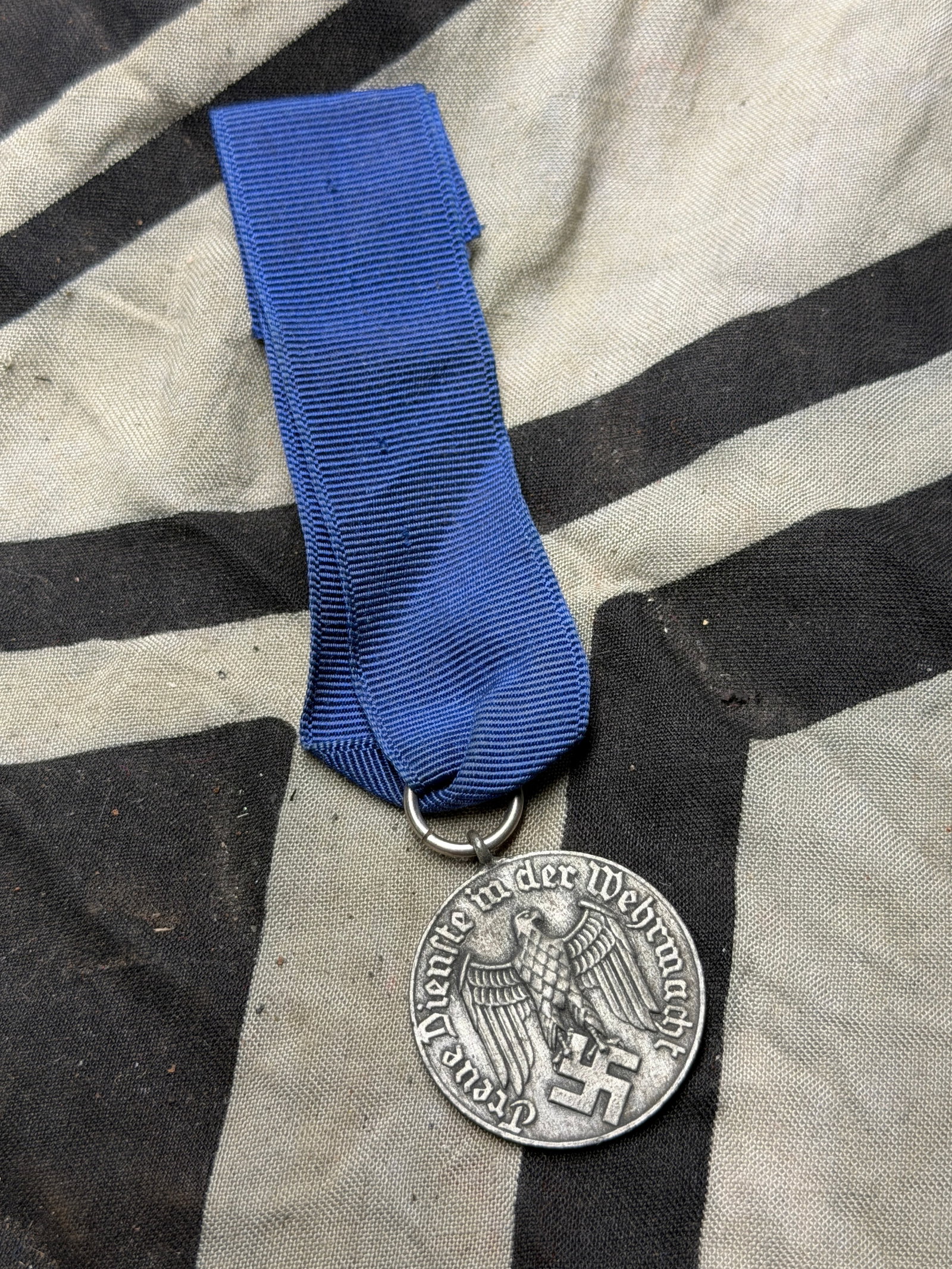WW2 German Third Reich-era German Wehrmacht Long Service Medal (Dienstauszeichnung der Wehrmacht): WW2 German Third Reich-era German Wehrmacht Long Service Medal (Dienstauszeichnung der Wehrmacht). Shows the German eagle holding a swastika (a historical symbol here, not used today except for docume