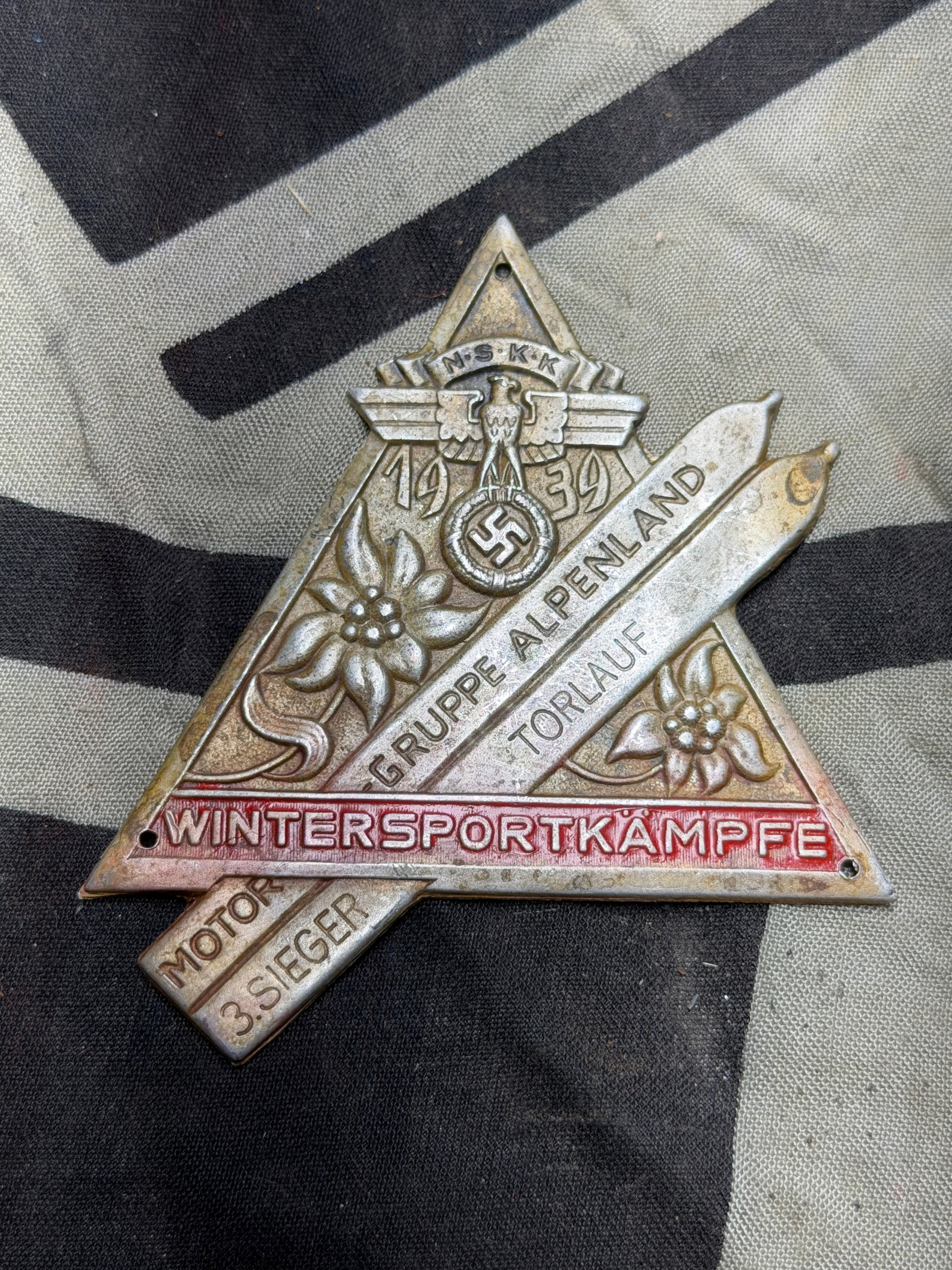 WW2 German NSKK Motorgruppe Alpenland 1939 Plaque – Alpine Kombination (1st Place Winner): WW2 German NSKK Motorgruppe Alpenland 1939 Plaque – Alpine Kombination (1st Place Winner). NSKK Motorgruppe Alpenland Siegerplakkette (Victory Plaque) for the “Wintersportkämpfe” of 1939 fo