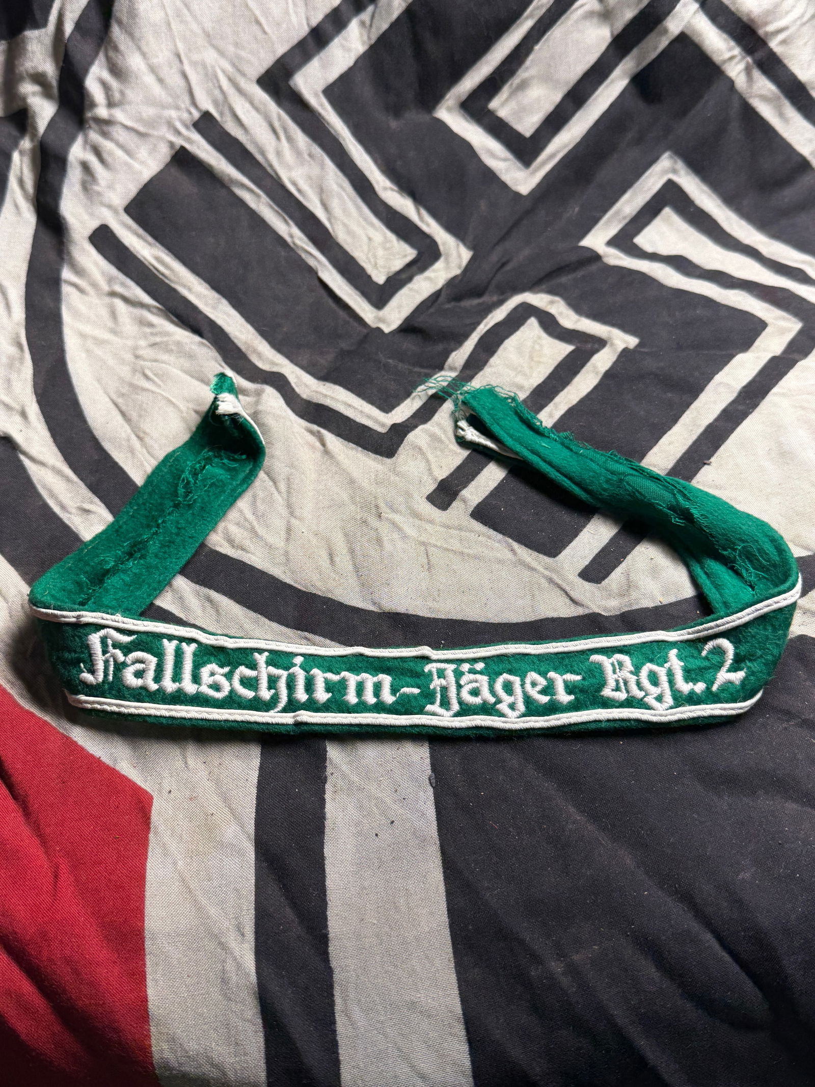 WW2 German Cuff Title (Armelband) for the Fallschirmjäger Regiment 2 (Paratrooper Regiment 2): WW2 German Cuff Title (Armelband) for the Fallschirmjäger Regiment 2 (Paratrooper Regiment 2). Green wool backing with machine-embroidered white Gothic script. Trim: White cotton edge piping. The Fal