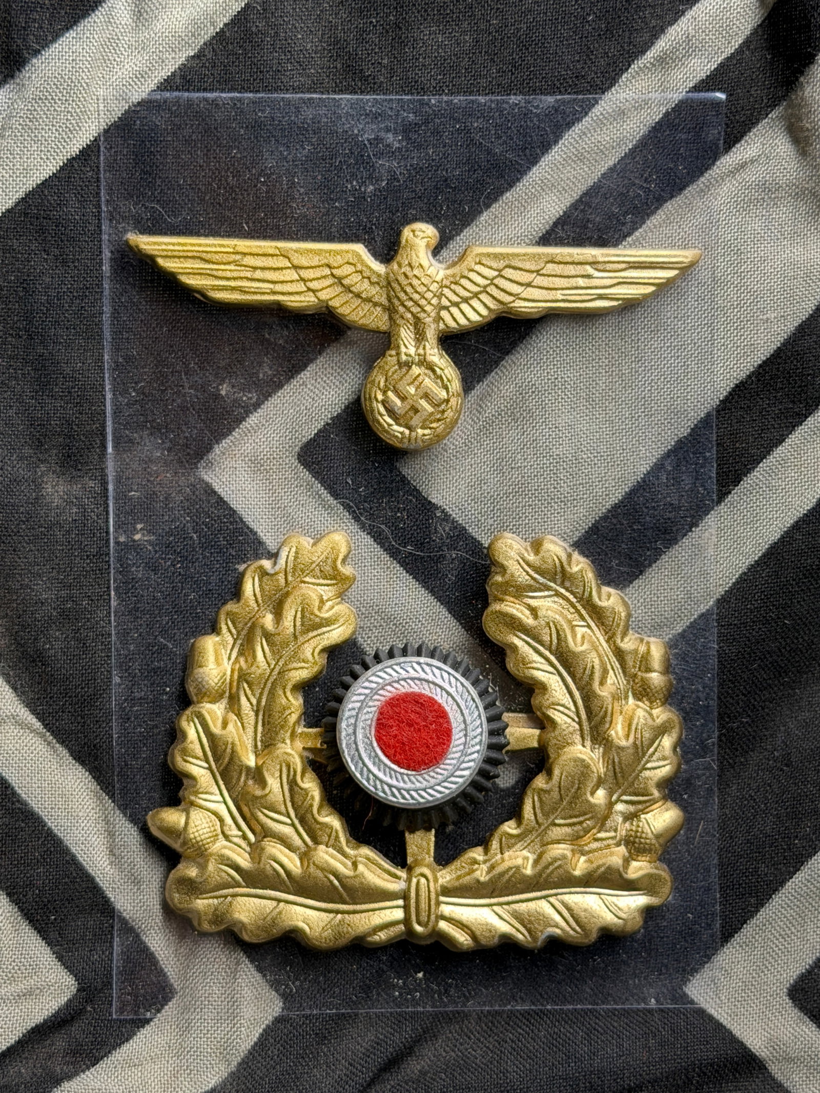 WW2 German Wehrmacht Heer eagle (Adler) Gold Gilt Insignia Set For Visor Cap: WW2 German Wehrmacht Heer eagle (Adler) Gold Gilt Insignia Set For Visor Cap. Maker marked on the reverse. Wehrmacht Heer eagle (Adler) – a gilt (gold-colored) metal insignia featuring a spread-wing