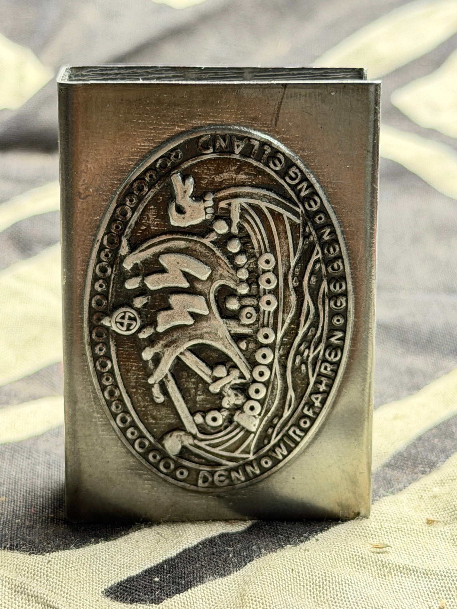 WW2 German Wiking SS Commemorative Silver Match case “For we are sailing against England.: WW2 German Commemorative Match case “For we are sailing against England.” The design depicts a Viking-style longship with a crew, under a swastika symbol, and bears the inscription “DENN WIR