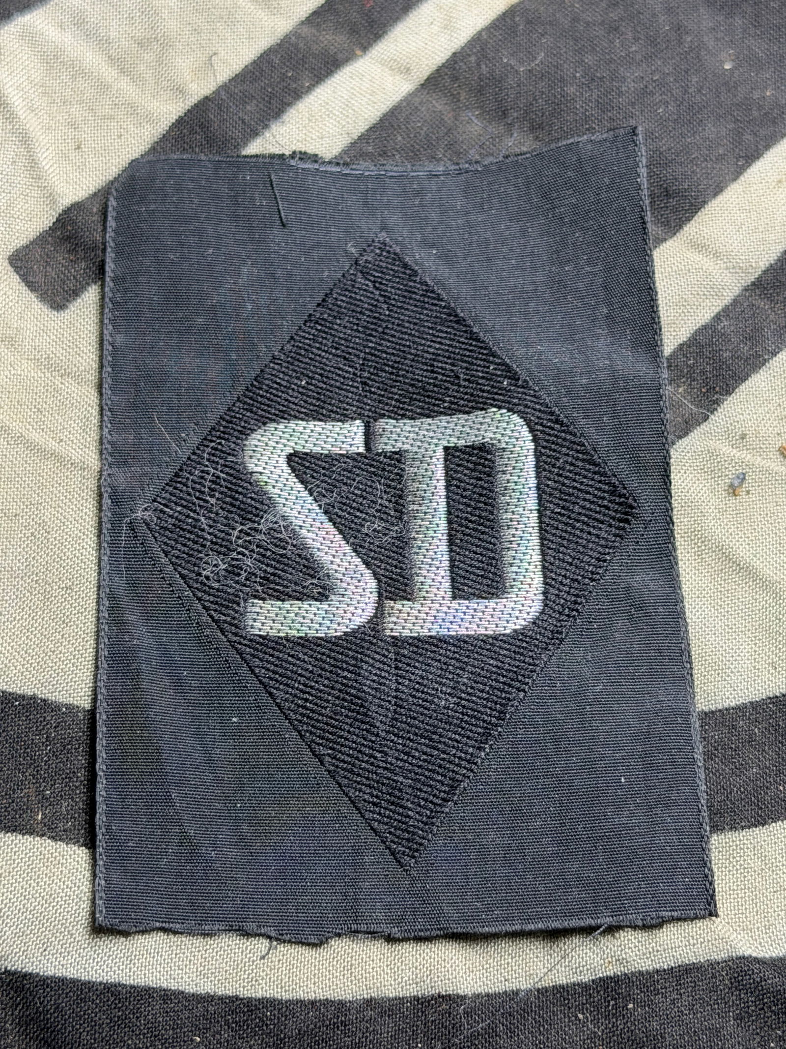 WW2 German Sicherheitsdienst or SD Diamond Sleeve Insignia: WW2 German Sicherheitsdienst or SD Diamond Sleeve Insignia. Security Service (Sicherheitsdienst or SD) sleeve insignia. The SD was the intelligence branch associated with the Nazi regime’s SS organi