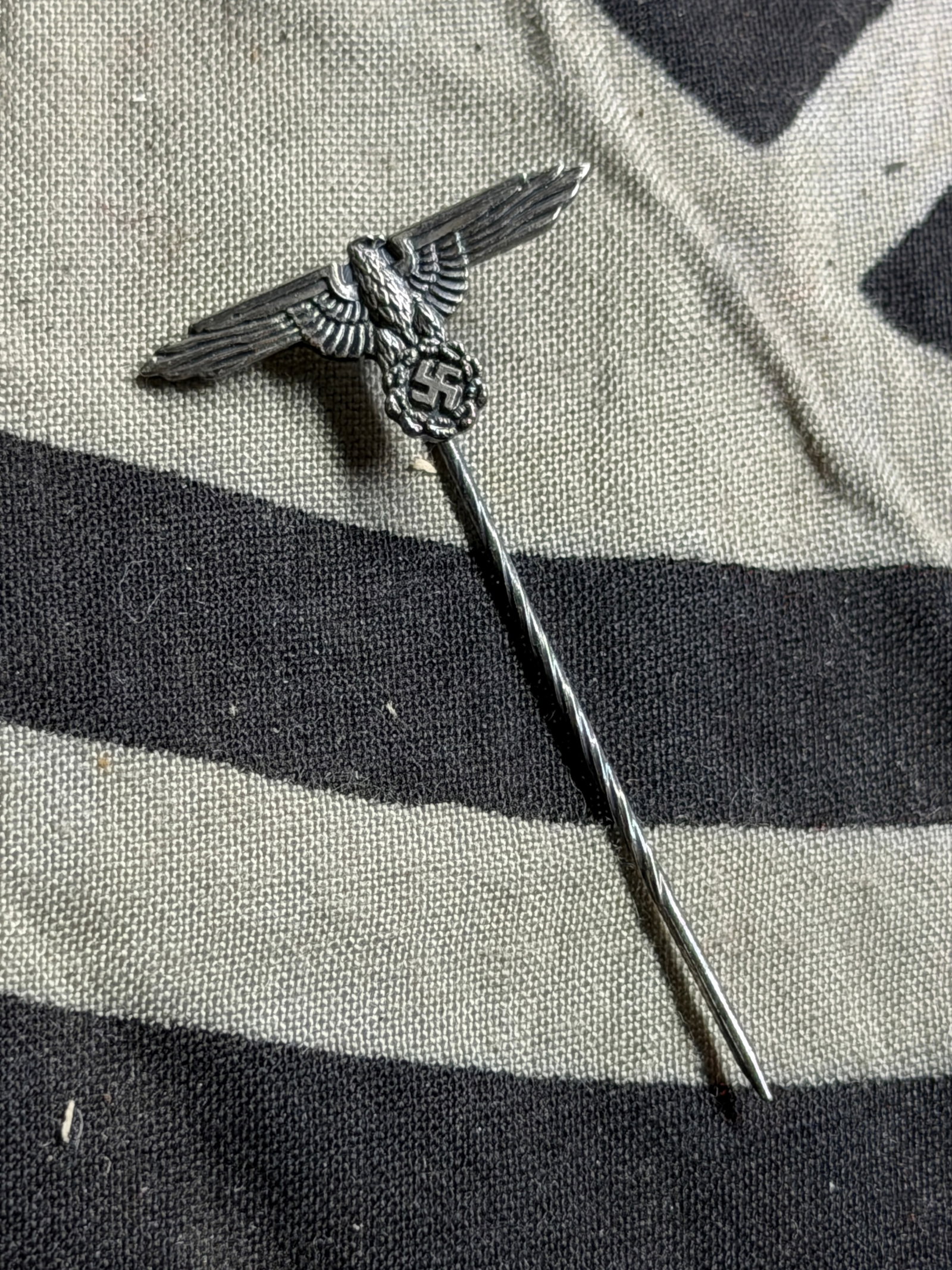 RARE WW2 GERMAN WAFFEN SS EAGLE TUNIC STICKPIN: RARE WW2 GERMAN WAFFEN SS EAGLE TUNIC STICKPIN. A RARE FIND. SHOWS GOOD WEAR AND USE WITH A BEUATIFUL OVERALL PATINA. A RARE EXAMPLE.