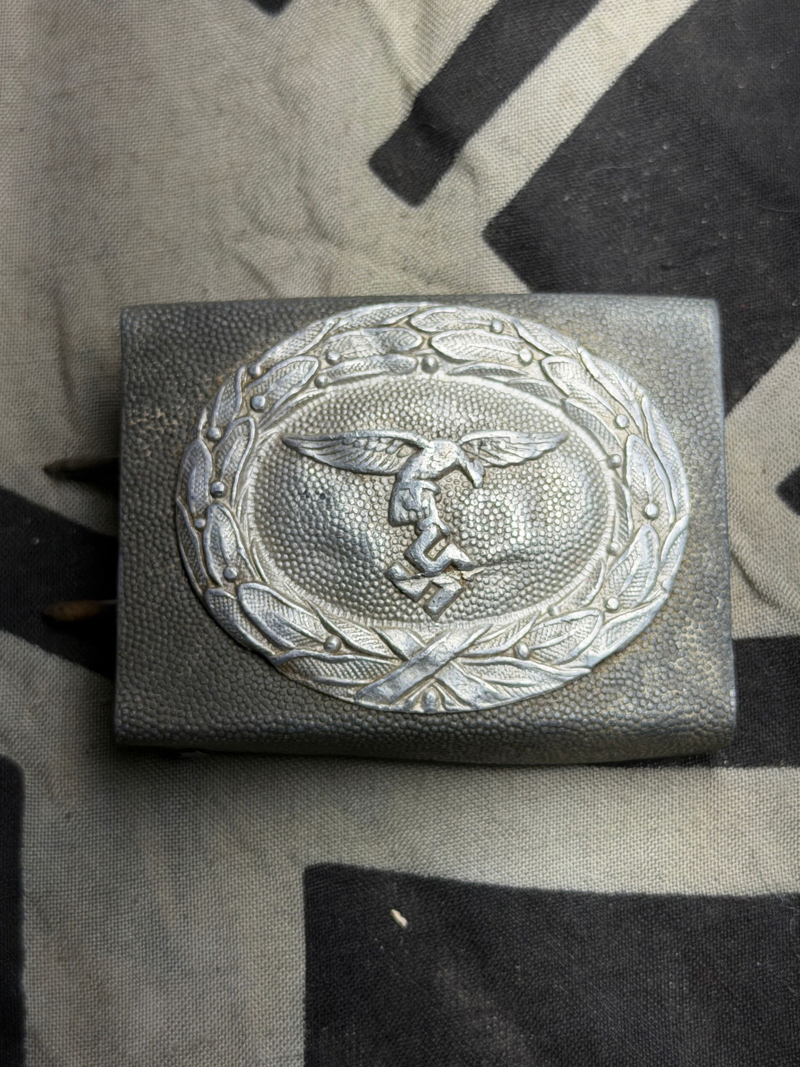 WWII German Luftwaffe (Airforce) EM/NCO’S BELT BUCKLE: Military belts and their corresponding buckles date back centuries and were initially designed for attaching swords and daggers. In 1847 a new innovative box buckle with a quick release catch and corr