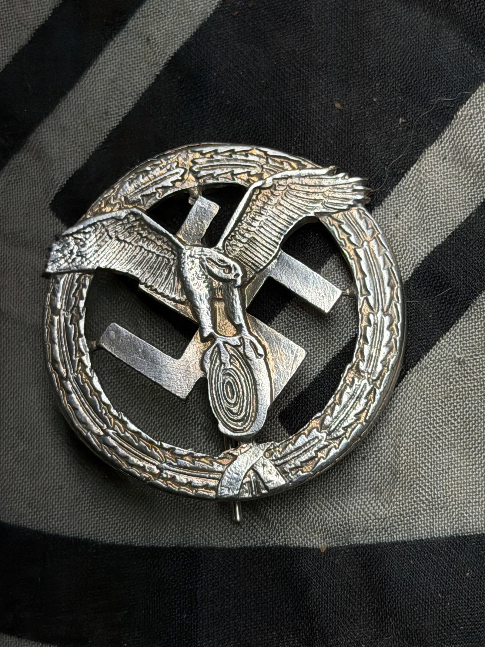 WWII German Motor Sports Badge 3rd Class By RZM 14: WWII German Motor Sports Badge 3rd Class By RZM 14. Shows good wear and use with a beautiful overall patina. Please view all detailed pictures. A rare example of the time period.