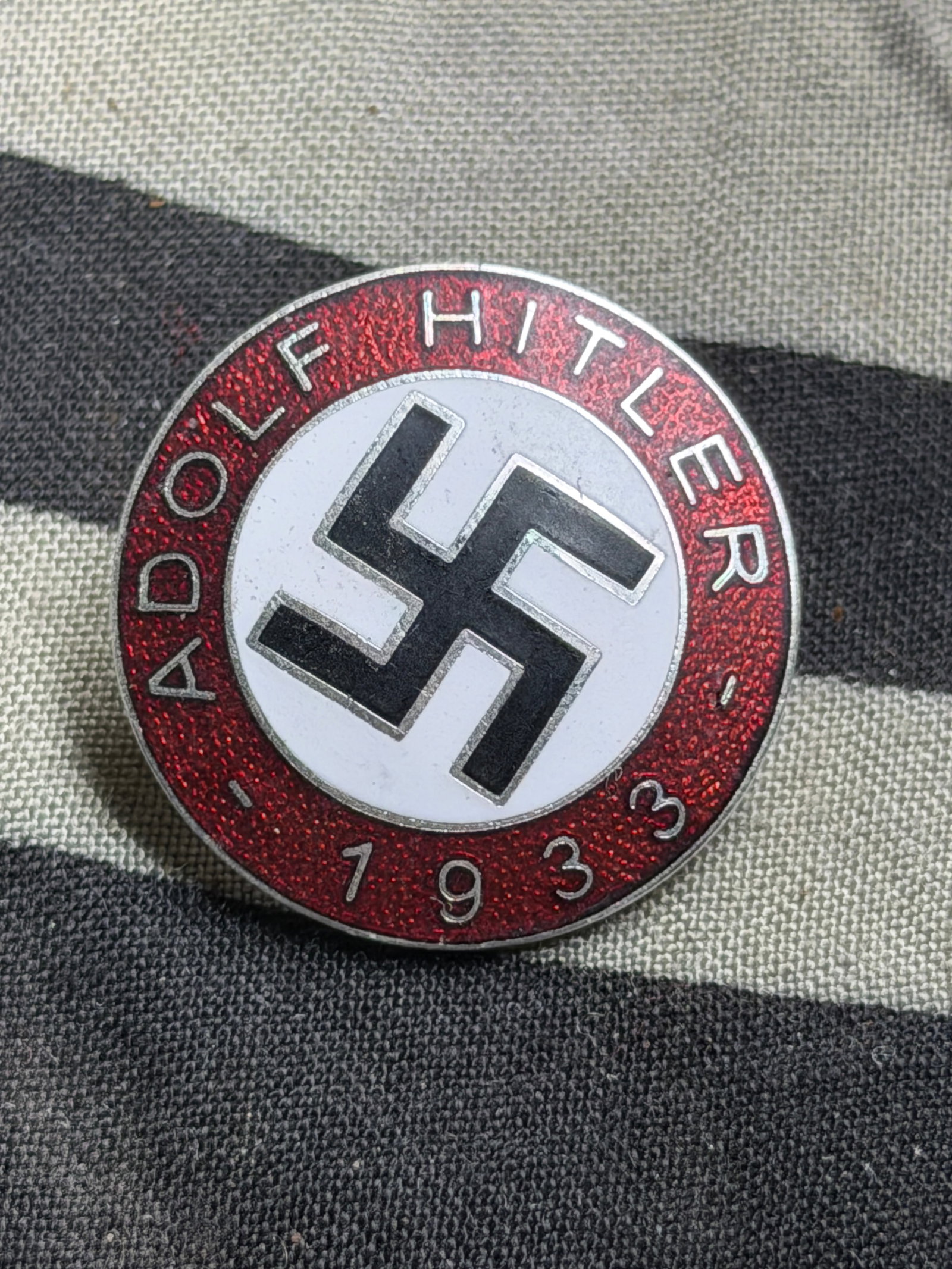 WW2 German Adolf Hitler 1933 Party Enameled Badge By RZM M1/129: WW2 German Adolf Hitler 1933 Party Enameled Badge By RZM M1/129. A rare example that is in mint overall shape and condition with a beautiful overall paitna. Please view all detailed pictures. A scarce