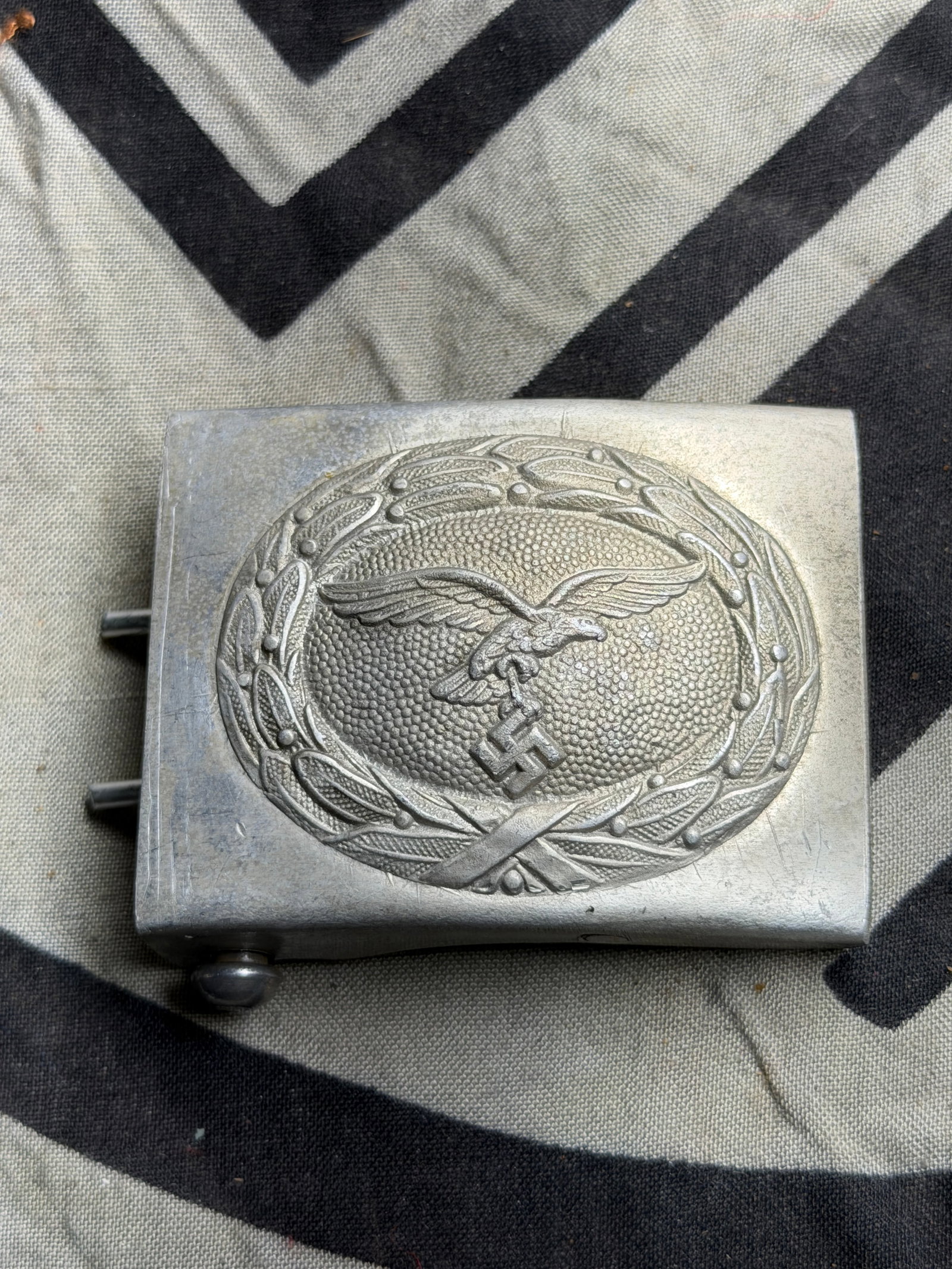 WW2 German Maker Marked Luftwaffe EM/NCO Belt Buckle in Aluminum RZM M34/2: WW2 German Maker Marked Luftwaffe EM/NCO Belt Buckle in Aluminum RZM M34/2. Void of any issues or repairs! This one has a really great look to it and overall I would rate this as an excellent example.