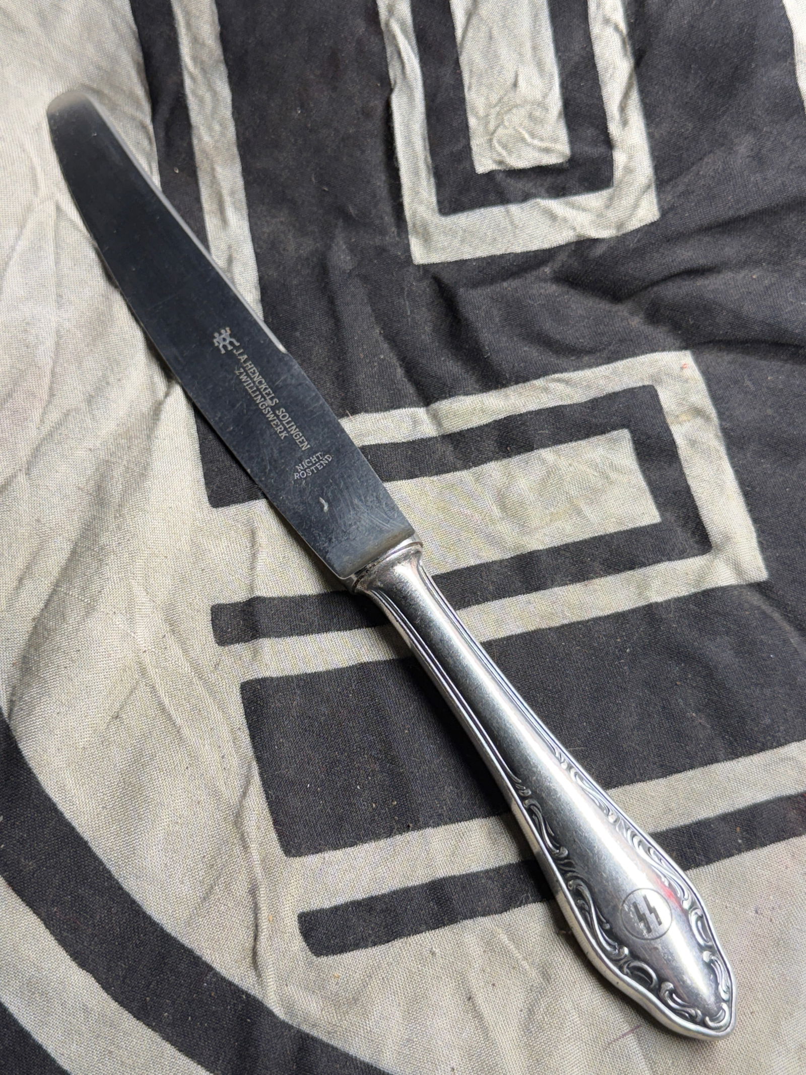 RARE WW2 GERMAN WAFFEN SS BUTTER KNIFE BY J.A. HENCKELS SOLINGEN: RARE WW2 GERMAN WAFFEN SS BUTTER KNIFE BY J.A. HENCKELS SOLINGEN. The handle bears an engraved symbol associated with the SS, the Schutzstaffel, a paramilitary organization active in Nazi Germany duri