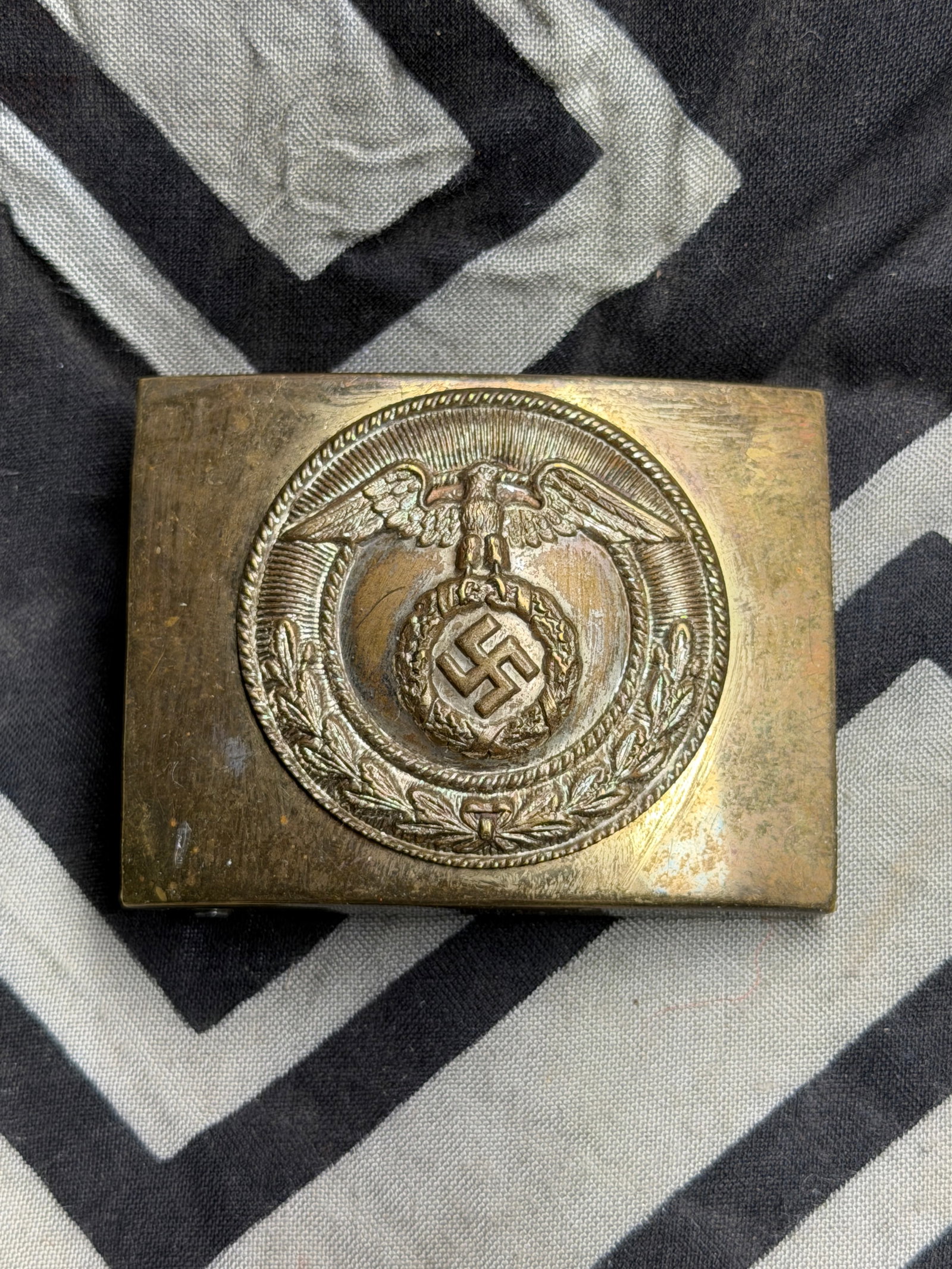 WW2 German NSDAP Enlisted Man's Brass Belt Buckle: Stamped-brass belt buckle for an enlisted man in the NSDAP or SA from 1930's Germany. Unmarked, but matches exactly one that was published in the bible of German Belt Buckles. This version has what is