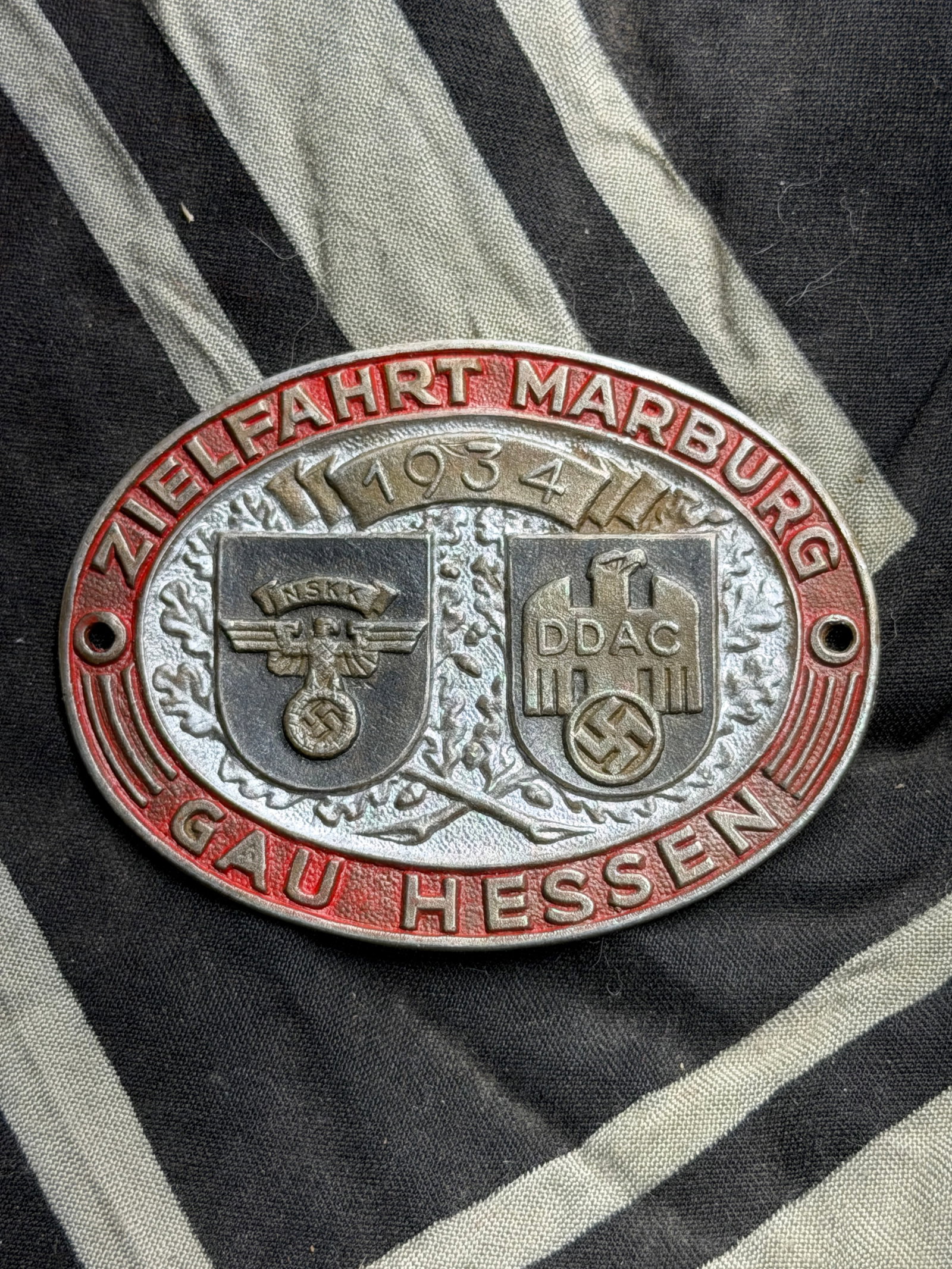WW2 German Shield for 1934 NSKK / DDAC "Destination Marburg" Rally: WW2 German Shield for 1934 NSKK / DDAC "Destination Marburg" Rally. A rare find. Shows good wear and use with a beautiful patina throughout. Please view all detailed pictures. A scarce example of the 