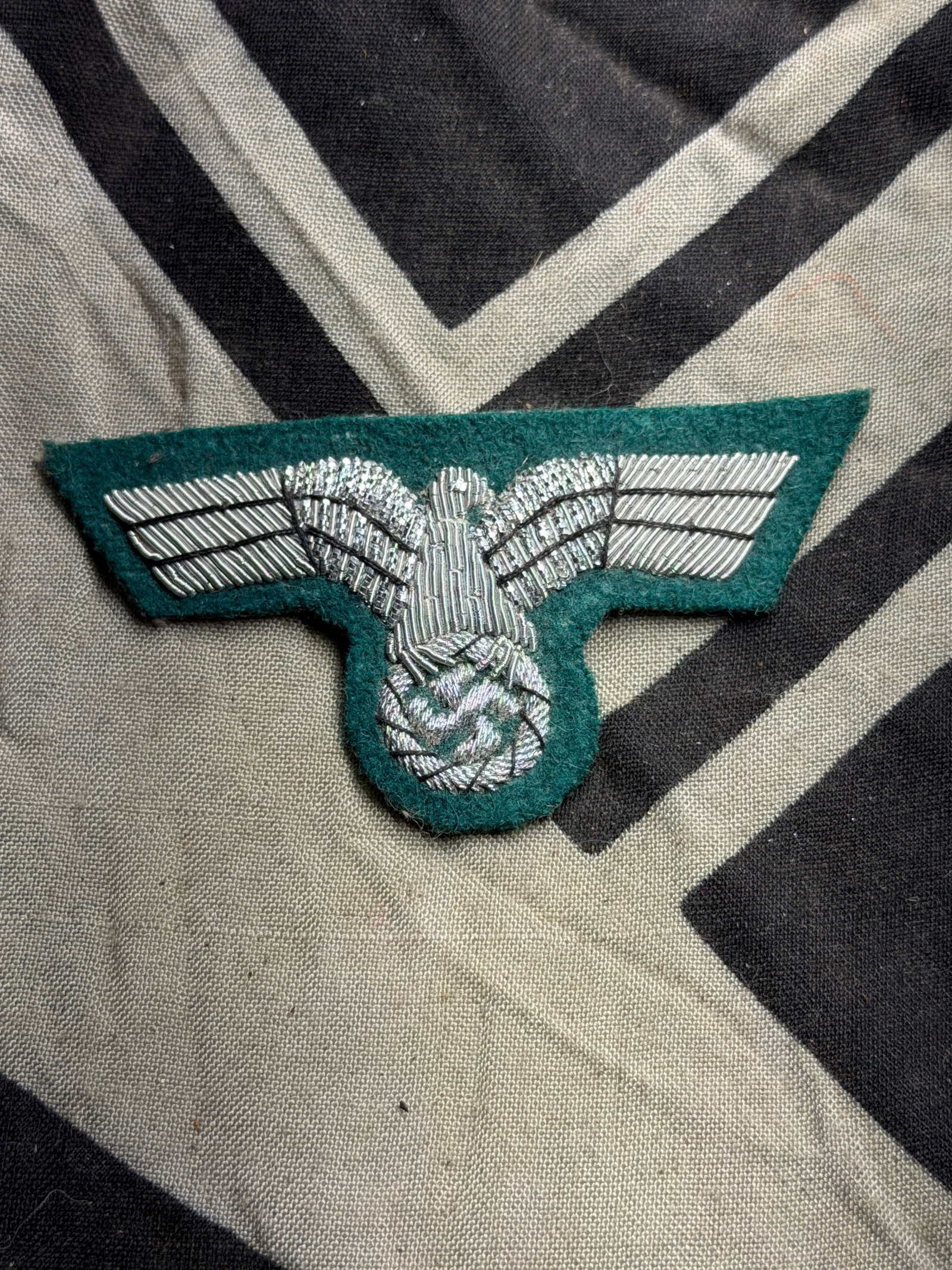 WWII bullion embroidered officer's eagle with green woolen base: WWII bullion embroidered officer's eagle with green woolen base. A rare find. Has a black cloth backing. An excellent example!