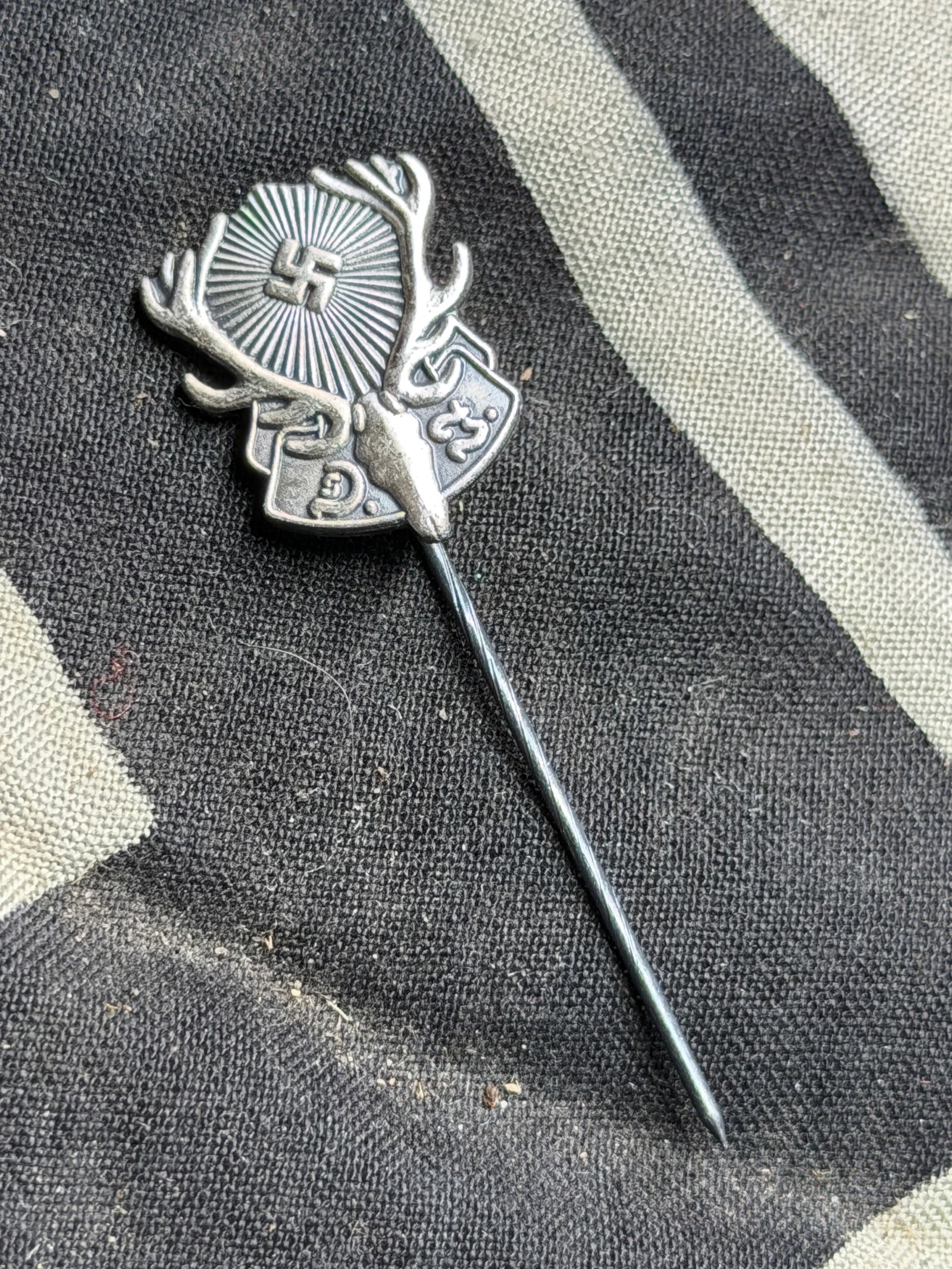 WW2 German Hunting Association lapel pin: Third Reich era German Hunting Association (Deutsche Jägerschaft) membership lapel pin. It measures around 2.1cm x 1.2cm, the rifled stickpin is around 4.7cm long.