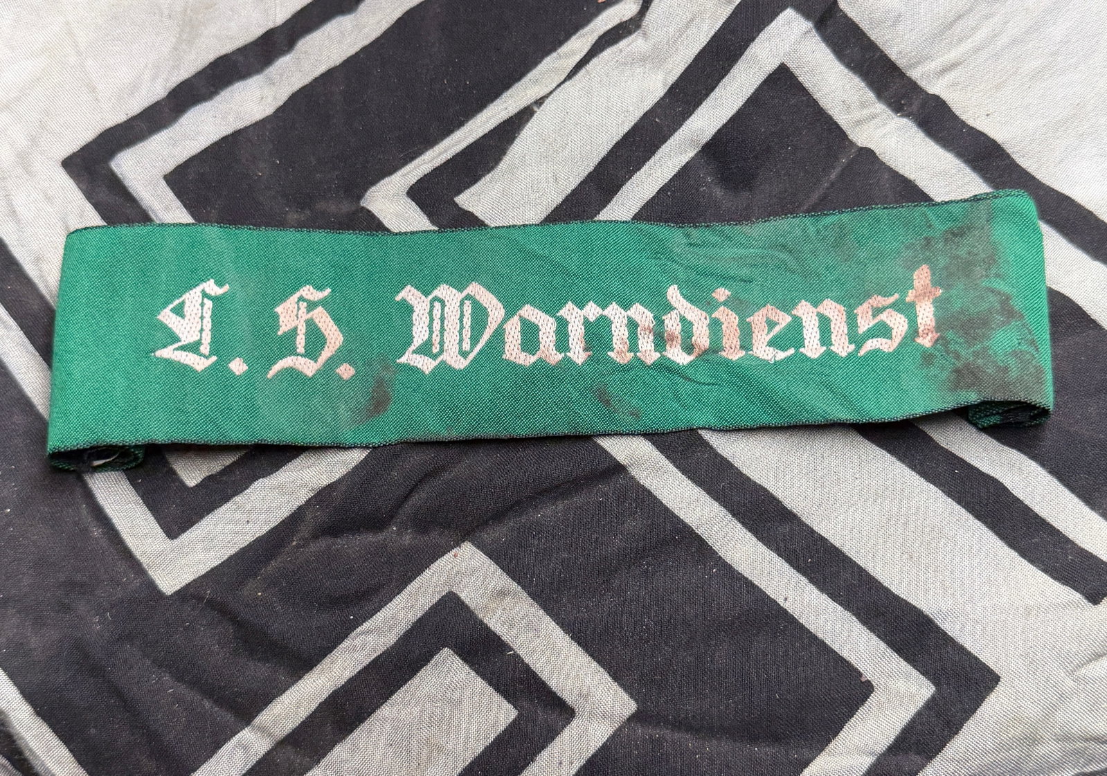 WW2 German Luftschutz Warndienst Cuff Title: Period L.S Warndienst (Luftschutzwarndienst) Air Raid Warning Service Cuff title, Full Length in Green of Rayon Construction with Bevo Woven Stitching, These were worn as a cuff title by both men and 