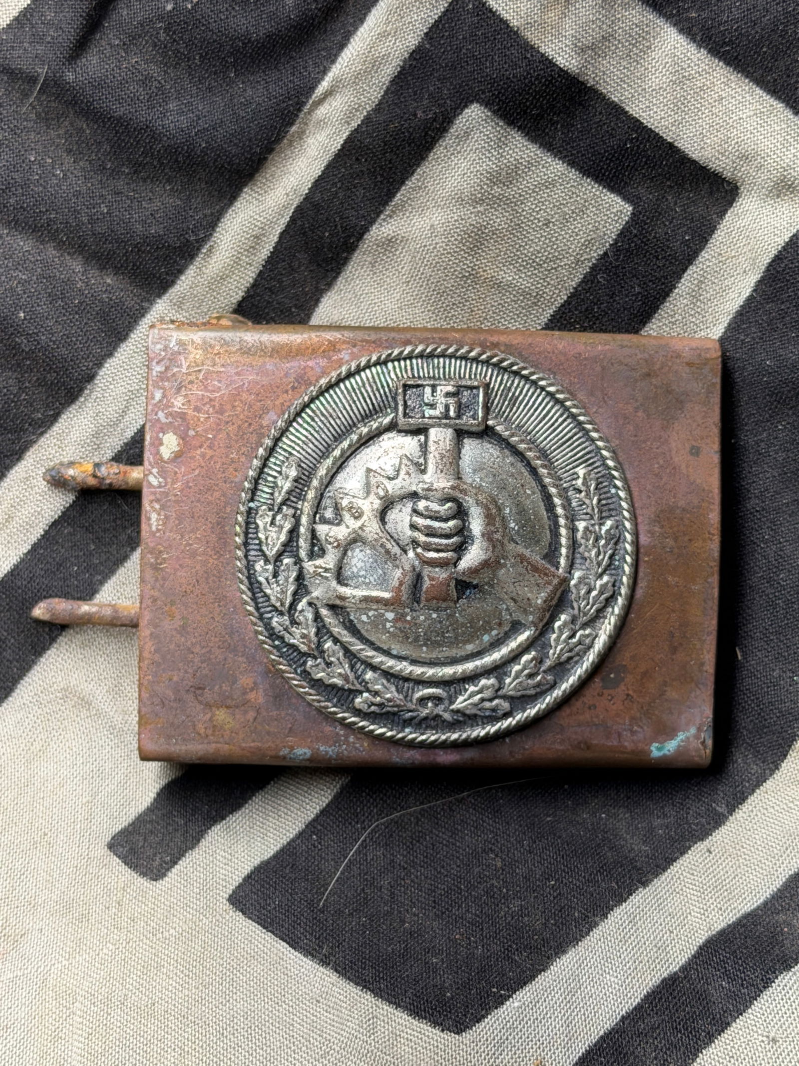 WW2 German Labor Front (DAF) Belt Buckle — Third Reich Era (circa 1933–1945): This brass and nickel-plated belt buckle features the emblem of the Deutsche Arbeitsfront (DAF), or German Labor Front — a state-controlled organization that replaced independent trade unions in Naz
