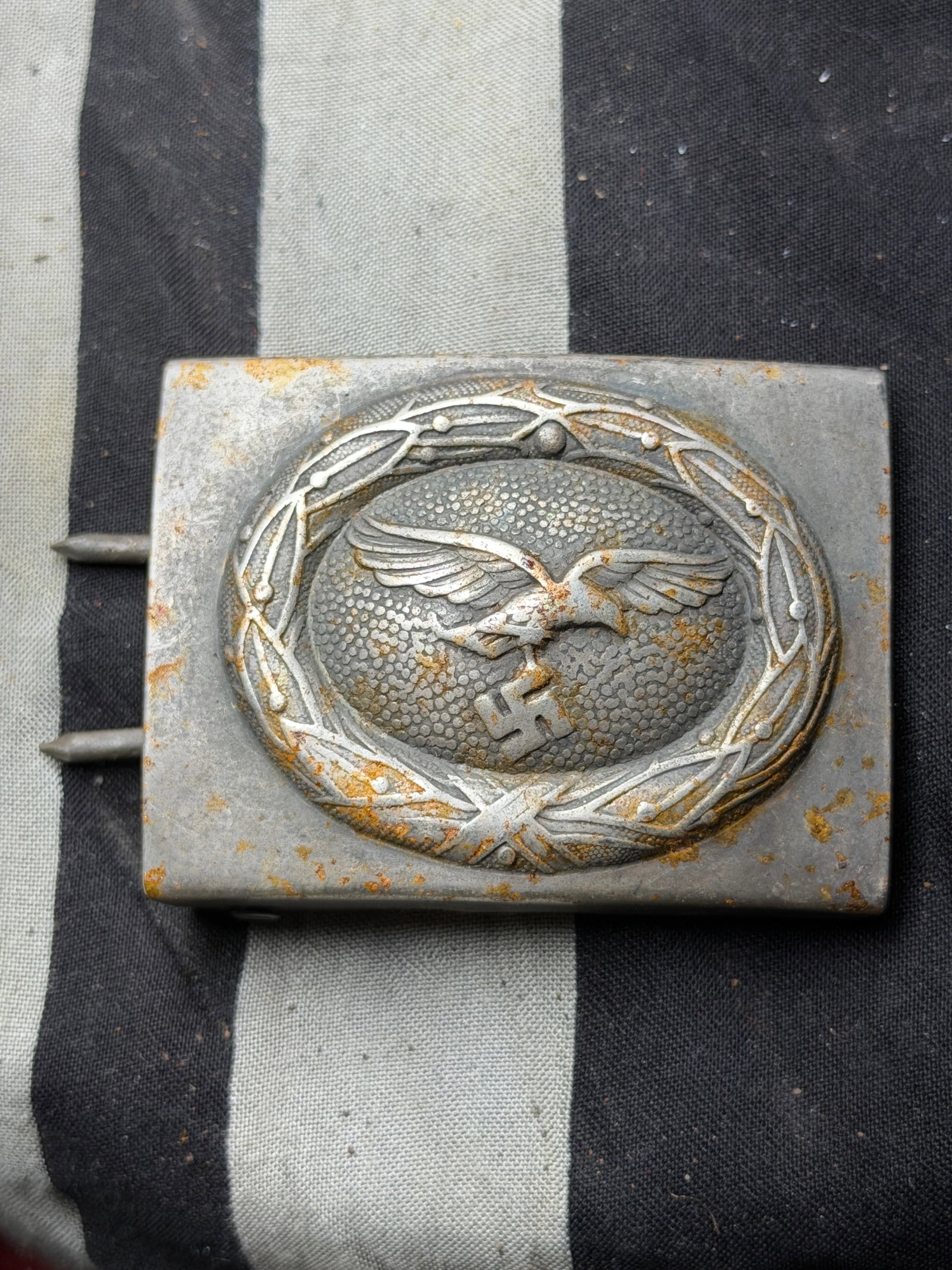 WW2 German Luftwaffe Enlisted Man’s Belt Buckle By B&N: WW2 German Luftwaffe Enlisted Man’s Belt Buckle By B&N. This rectangular aluminum belt buckle features the Luftwaffe’s distinctive emblem: a spread-winged eagle clutching a swastika, encircled by 