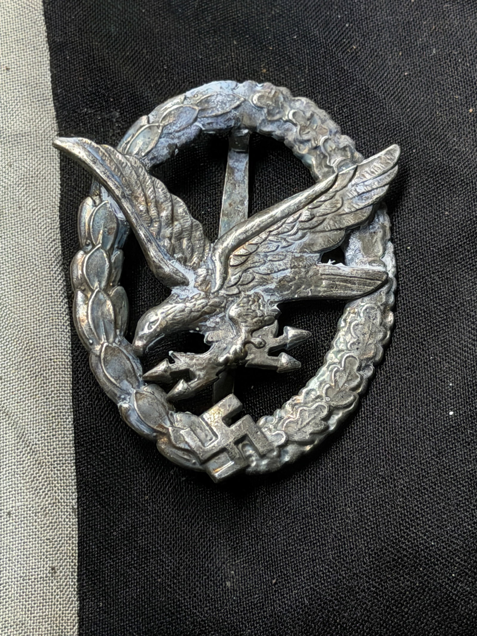Luftwaffe Pilot’s Badge Maker: Berg & Nolte, Lüdenscheid (B&NL), WW2 Germany, circa 1939–1945: This silver-toned badge, measuring approximately 2.25 inches in height, is a Luftwaffe Pilot’s Badge (Flugzeugführerabzeichen), awarded to qualified pilots of the German Air Force during the era of