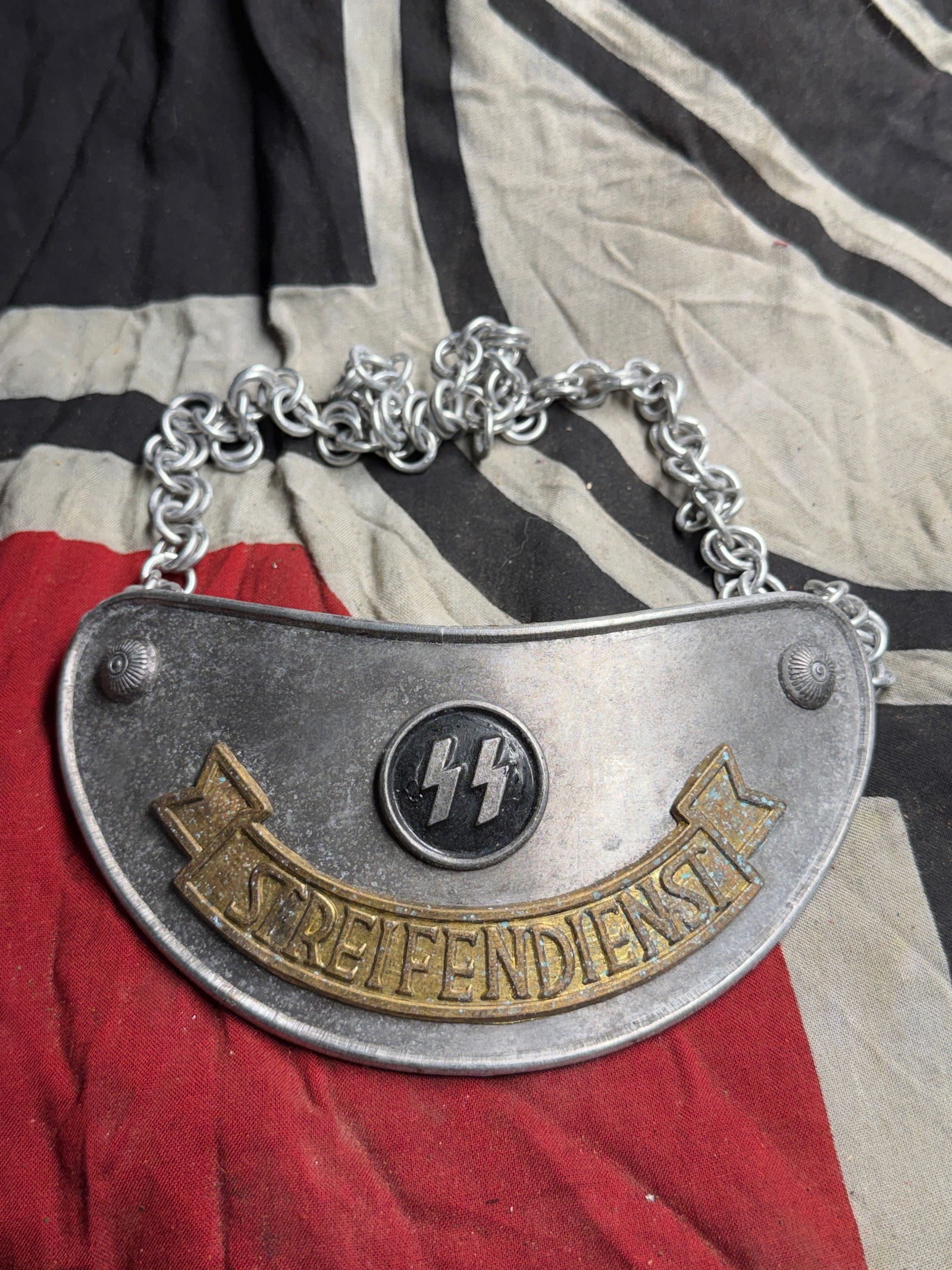 WW2 German SS “Streifendienst?? Gorget circa 1936–1945: WW2 German SS “Streifendienst” Gorget circa 1936–1945. This artifact is an SS “Streifendienst” gorget, a metal insignia worn around the neck by members of the Schutzstaffel (SS) patr