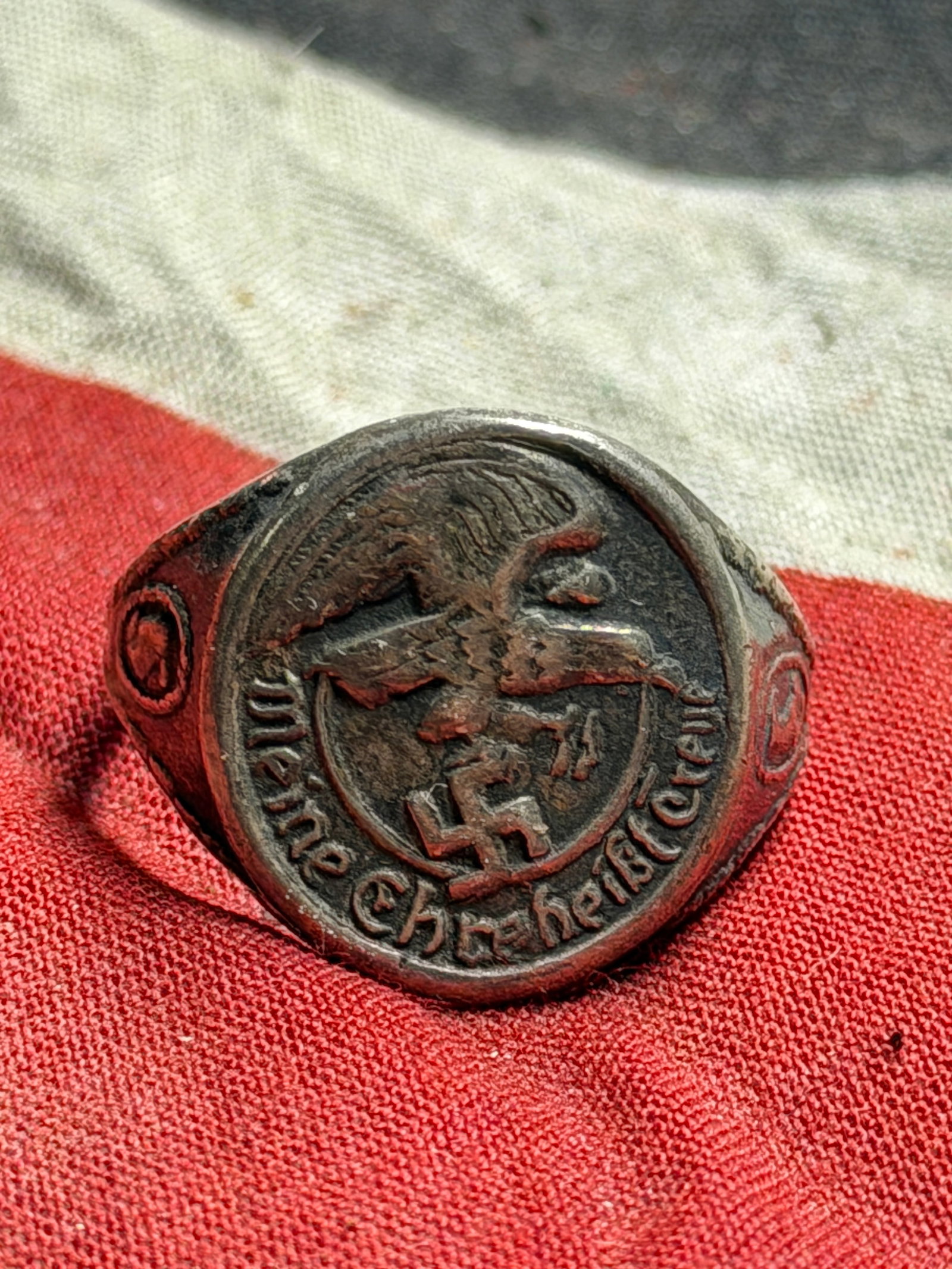 WW2 German “Meine Ehre heißt Treue?? SS Honor Ring In 800 Silver: This artifact is a Third Reich-era SS ring crafted in silver, bearing the inscription “Meine Ehre heißt Treue” (“My Honor is Loyalty”), the motto of the Schutzstaffel (SS). The centra