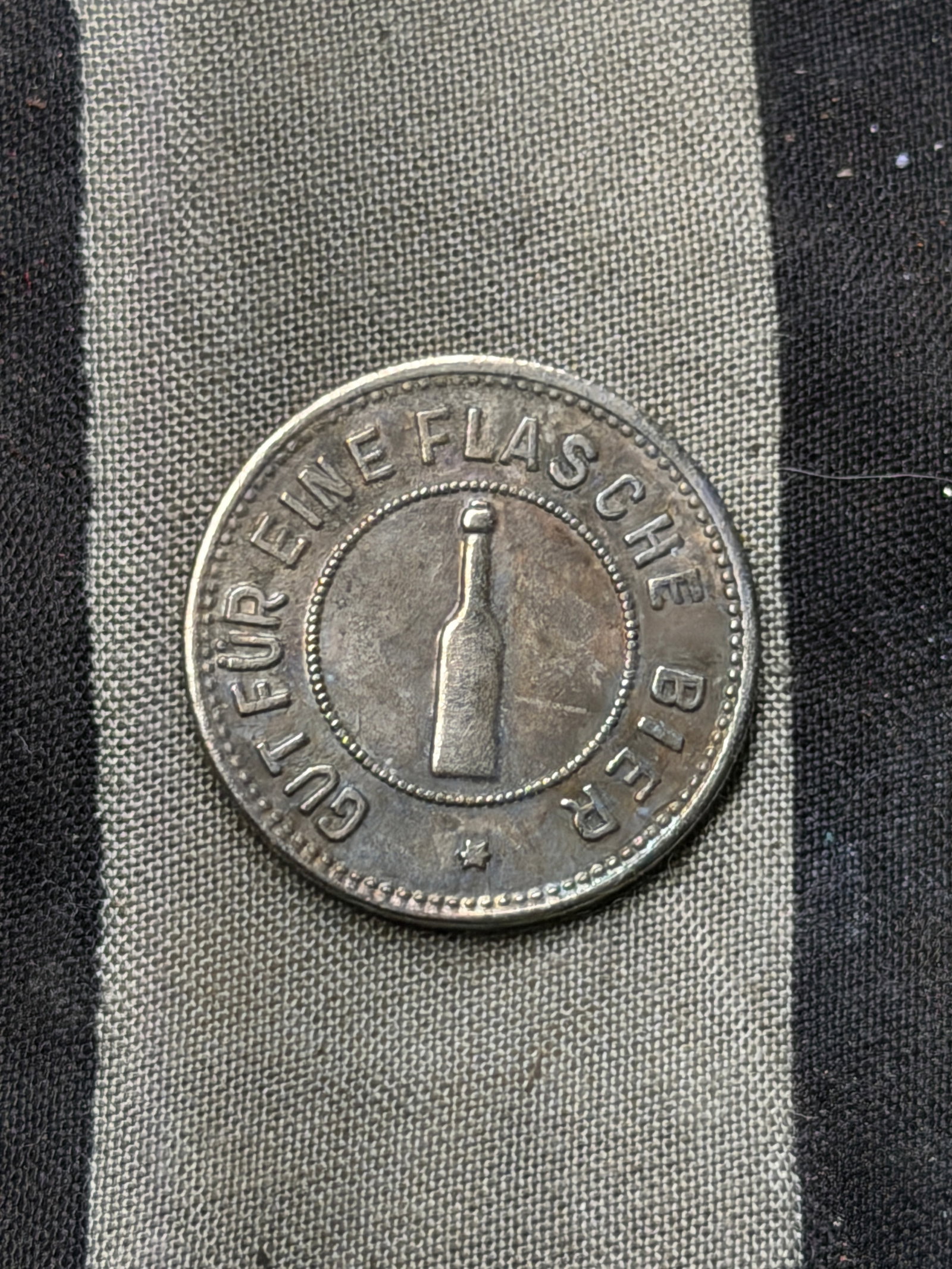 WW2 German Beer Silver Token from the NSDAP Gauführerschule: WW2 German Beer Silver Token from the NSDAP Gauführerschule. This small circular token, approximately 1.25 inches (3.2 cm) in diameter, is struck in metal and bears inscriptions on both sides. One fa