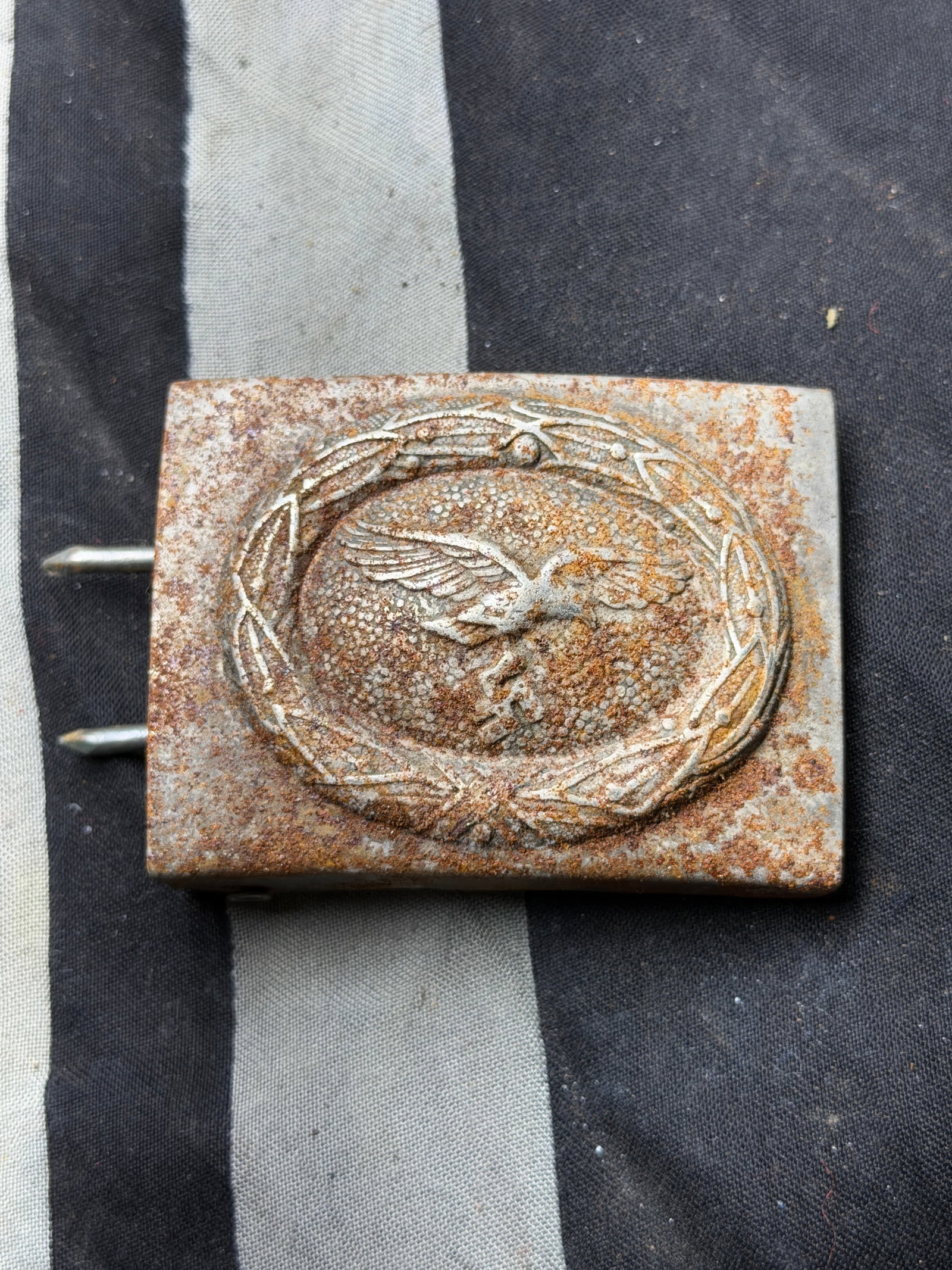 WW2 German Luftwaffe Enlisted Man’s Belt Buckle With Maker Marks: WW2 German Luftwaffe Enlisted Man’s Belt Buckle With Maker Marks. This rusted yet well-preserved rectangular Luftwaffe belt buckle was issued to enlisted men and non-commissioned officers (NCOs) ser