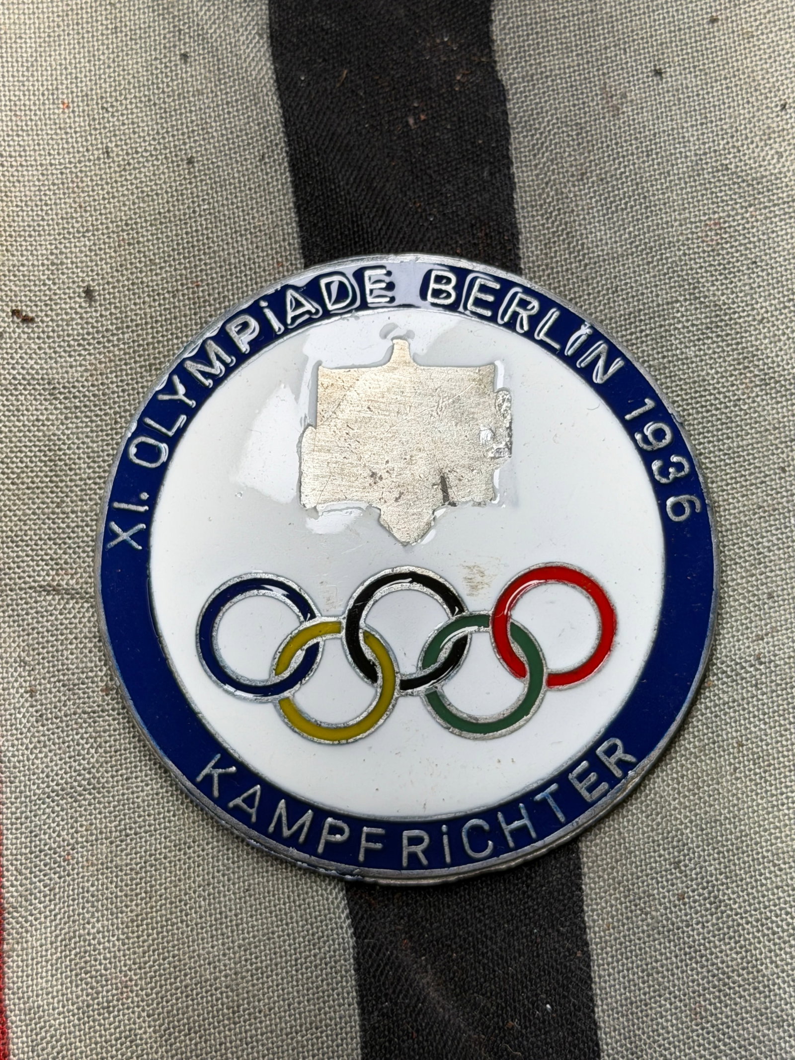 WW2 German Official Judge’s Badge — XI Olympiad, Berlin 1936 By Ges. Gesch.: WW2 German Official Judge’s Badge — XI Olympiad, Berlin 1936 By Ges. Gesch. This circular enameled metal badge, approximately 2.25 inches (5.7 cm) in diameter, was issued to Kampfrichter (competit