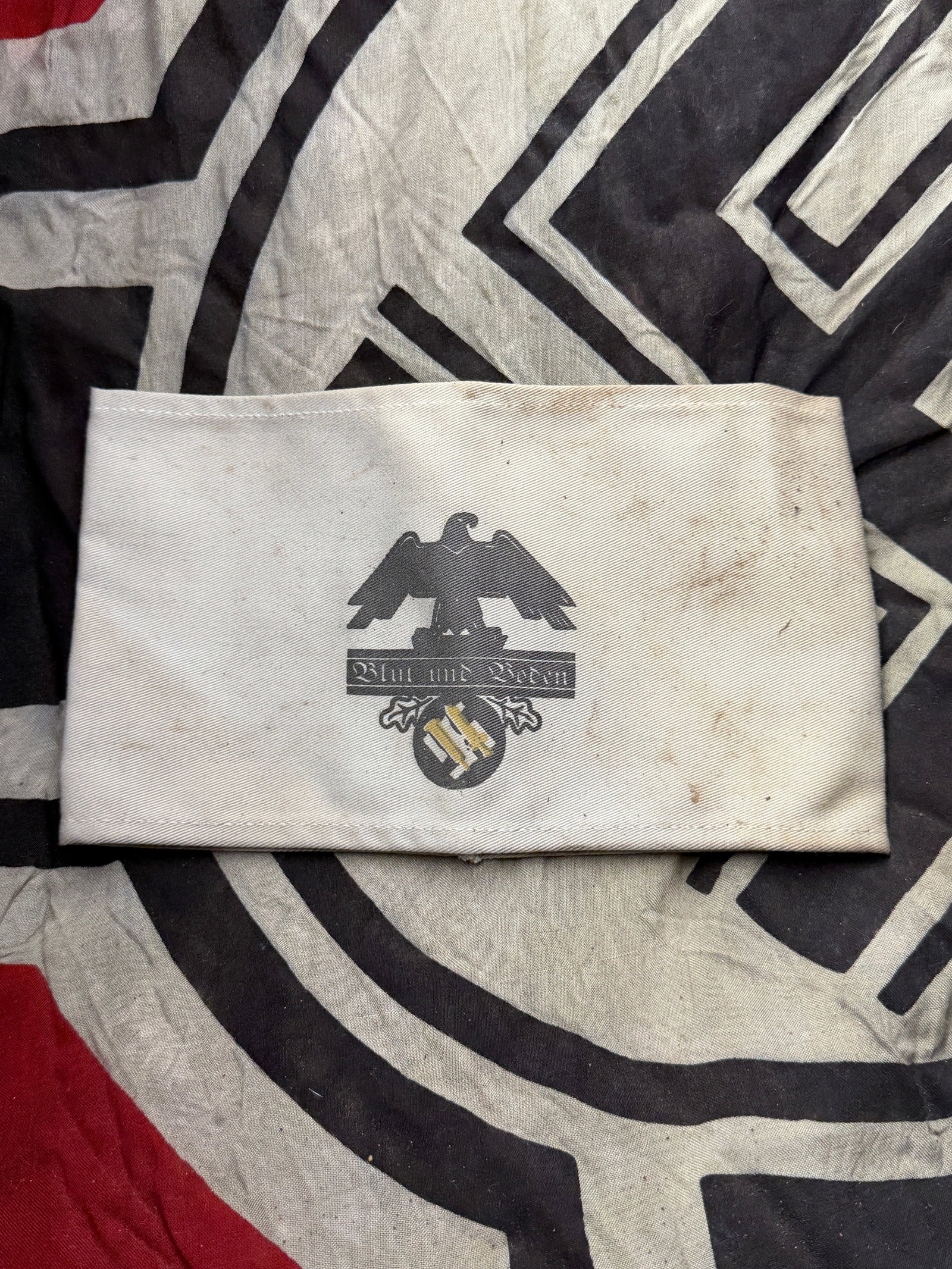 WW2 German “Blut und Boden?? Armband: WW2 German “Blut und Boden” Armband. This artifact is a “Blut und Boden” (Blood and Soil) armband, an emblematic piece of Nazi propaganda issued during the Third Reich. The phrase “B