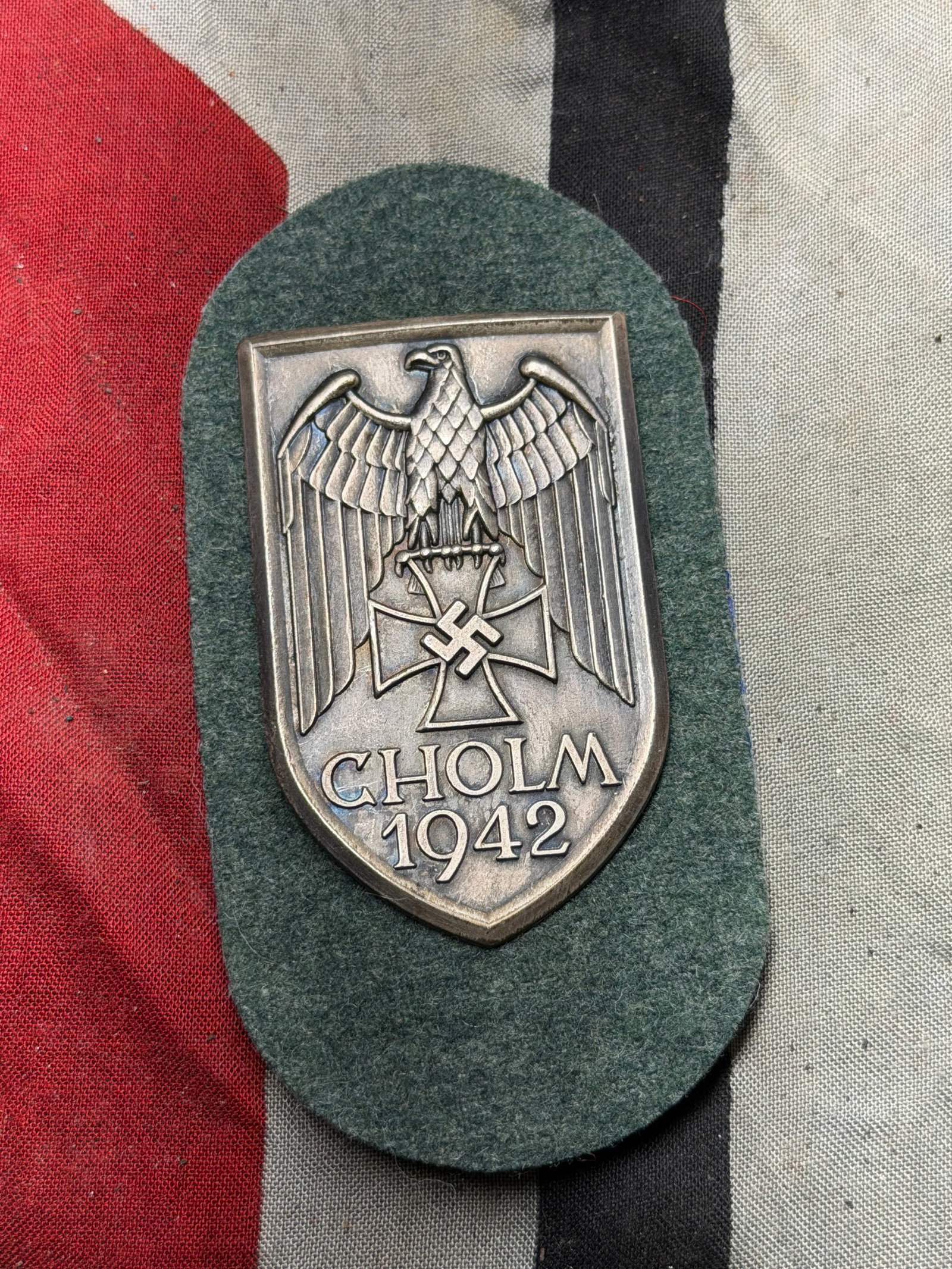 WW2 German Cholm Shield Campaign Award, 1942: This artifact is a Cholm Shield (Cholmschild), a German military campaign decoration instituted in July 1942. It was awarded to soldiers who participated in the defense of the Cholm Pocket, a brutal a