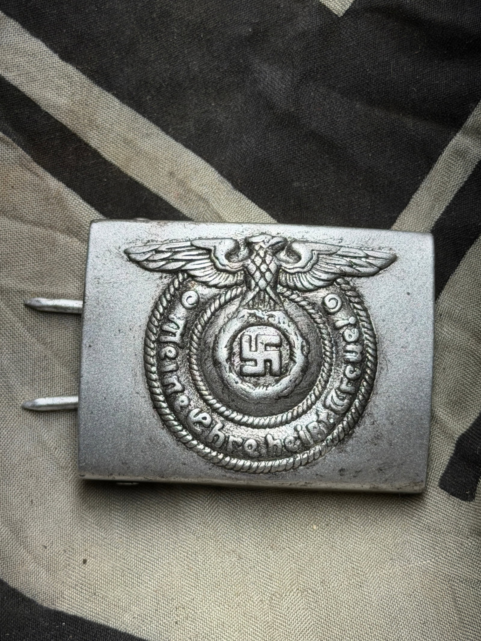 German WWII-Era Waffen SS Enlisted Man’s Belt Buckle (Stamped “B&N??): German WWII-Era Waffen SS Enlisted Man’s Belt Buckle (Stamped “B&N”). Aluminum belt buckle from the period of the Second World War, featuring the national eagle emblem clutching a wreath sur