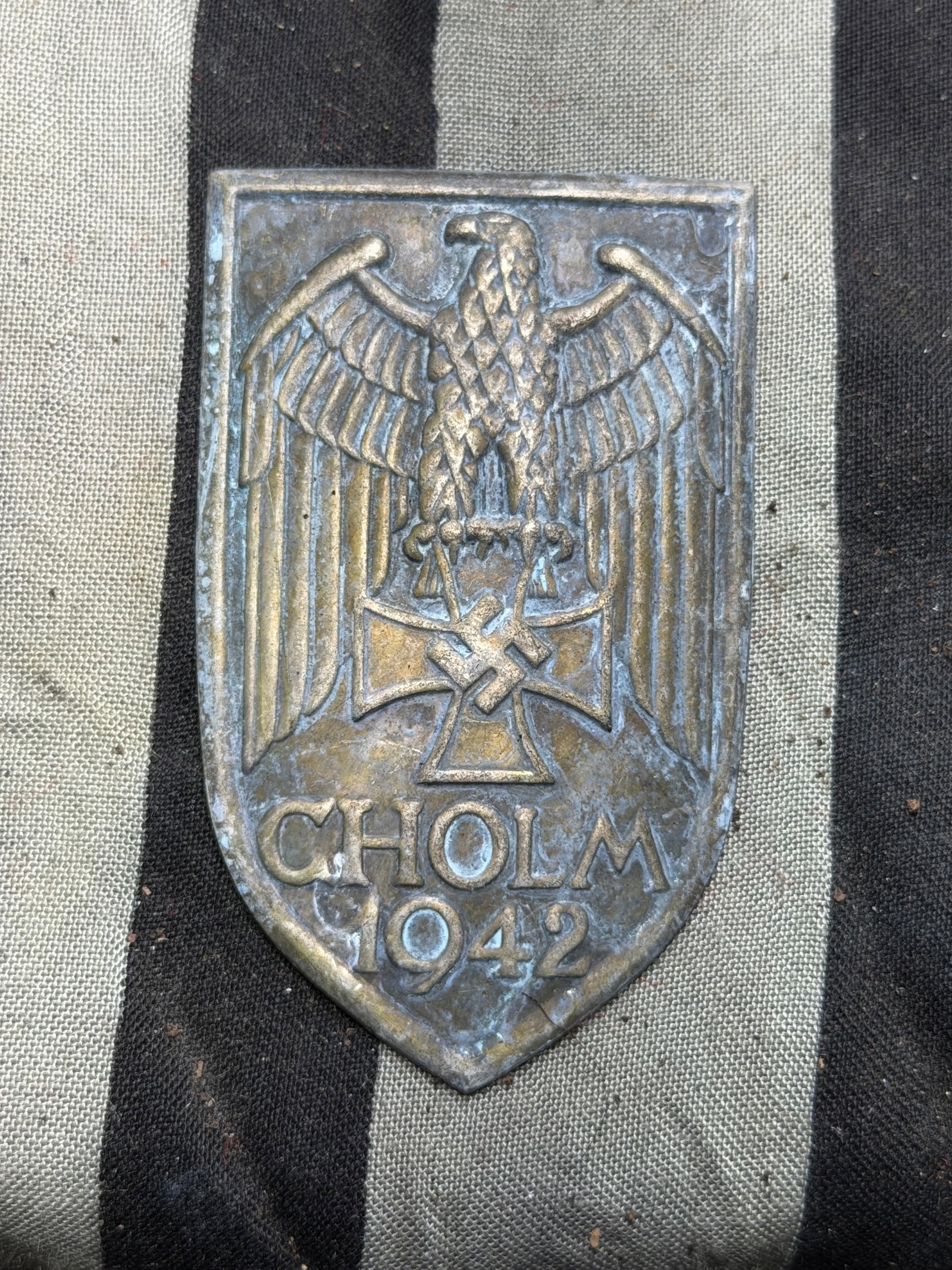 Cholm Shield, WW2 Germany, 1942: This metal shield-shaped badge, known as the Cholm Shield, was produced in 1942 during the Second World War. It was awarded to German soldiers who participated in the defense of the small Russian town