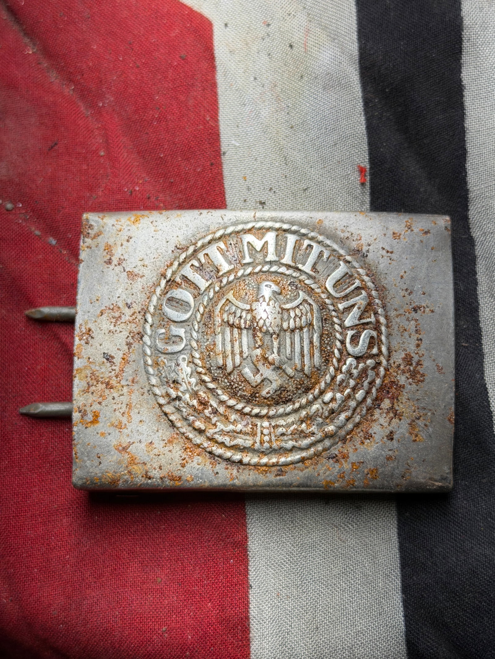 WW2 German Wehrmacht Enlisted Man’s Belt Buckle — “Gott mit uns,?? circa 1939–1945 By B&N: This metal belt buckle, measuring approximately 2.25 x 2 inches (5.7 x 5.0 cm), features a raised central motif of the German national eagle clutching a wreath surrounding a swastika, encircled by the