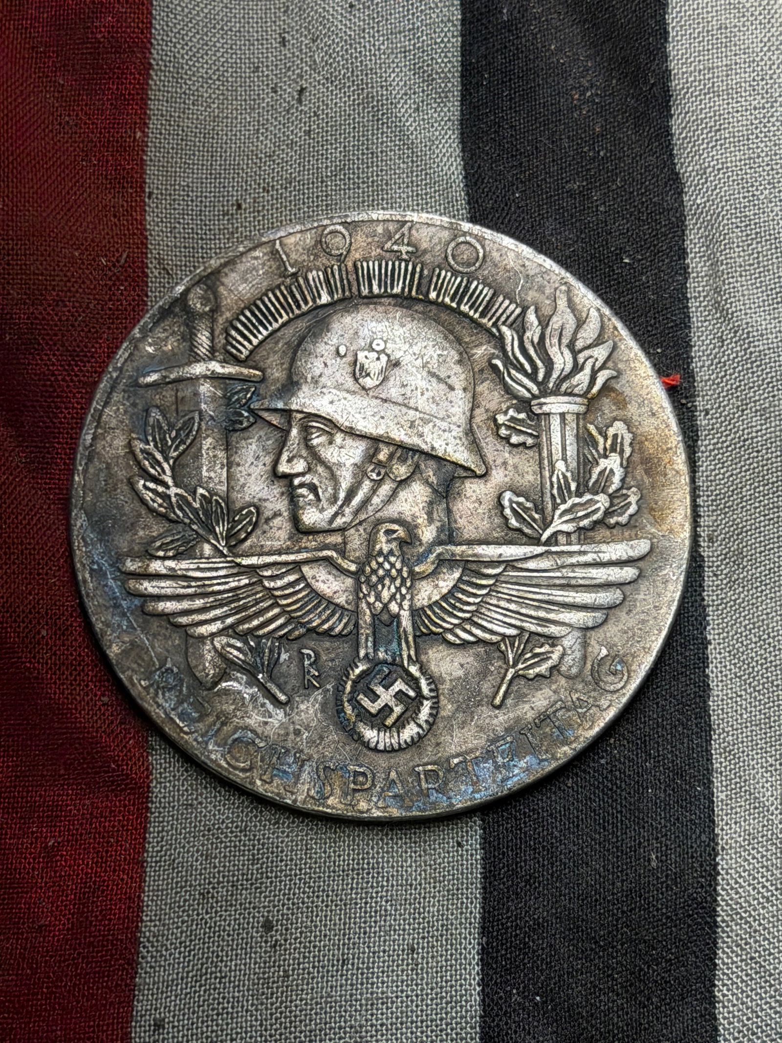 WW2 German Commemorative Silver Medal – Reichsparteitag 1940 (German National Party Day Medal): This circular commemorative medal dates to 1940 and was issued in connection with the Reichsparteitag (National Party Day) events of the German Third Reich period. The obverse (front) features a relie