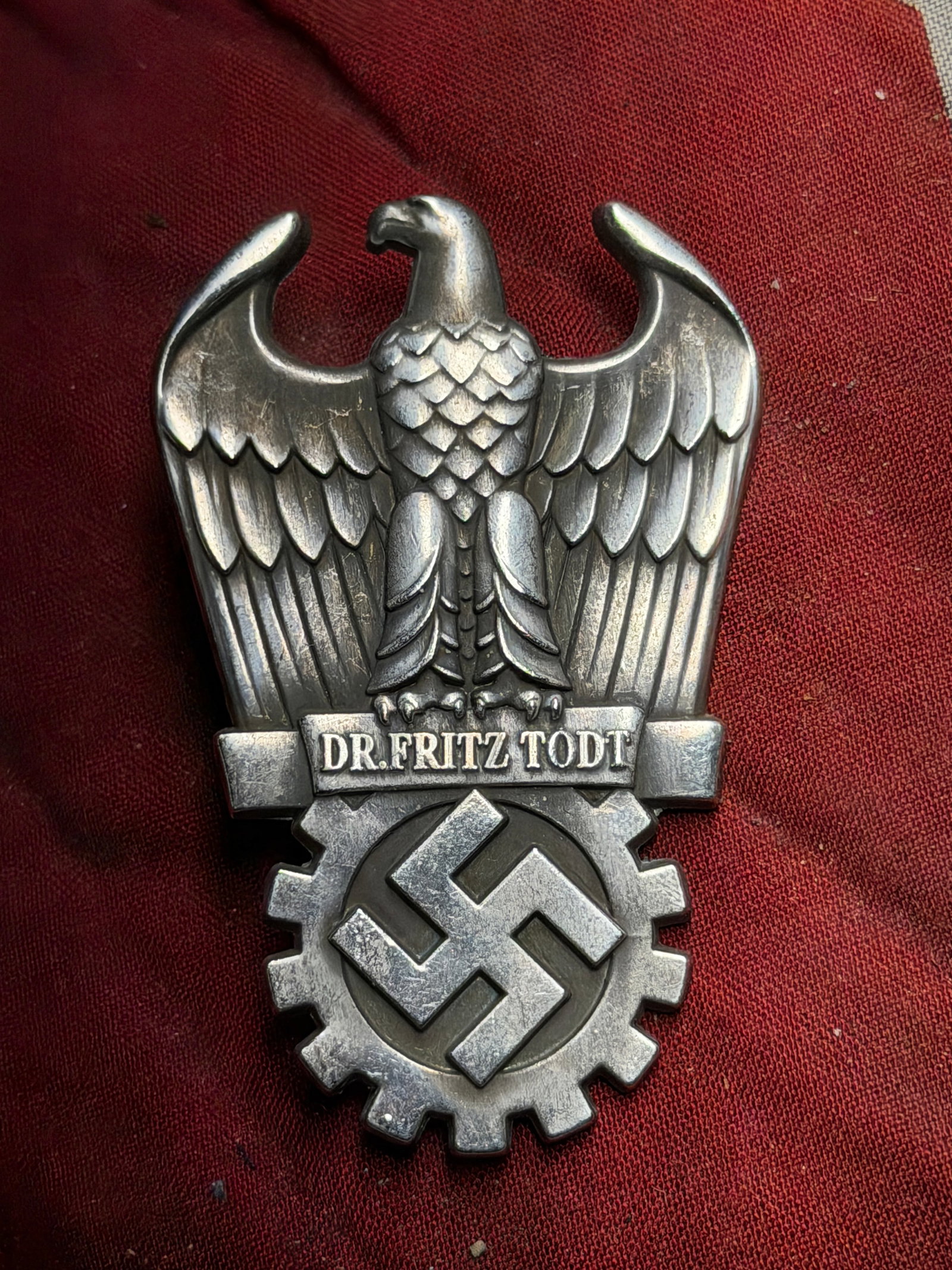 WW2 German Dr. Fritz Todt Commemorative Engineering Badge Circa 1940s: This metal badge is associated with the organization led by Dr. Fritz Todt, an engineer and senior figure in Germany’s wartime construction and infrastructure programs. The badge features a stylized