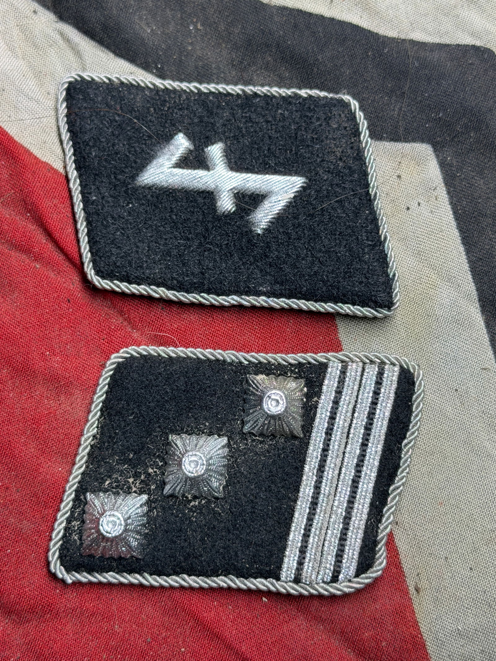 WW2 GERMAN SS BRIGADE & SS NEDERLAND FOREIGN VOLUNTEER UNIT OFFICER COLLAR TABS WITH RZM PAPER TAG: GERMAN SS BRIGADE & SS NEDERLAND FOREIGN VOLUNTEER UNIT OFFICER COLLAR TABS WITH RZM PAPER TAG. These collar insignia are examples of military-style rank patches used in Germany during the period of N