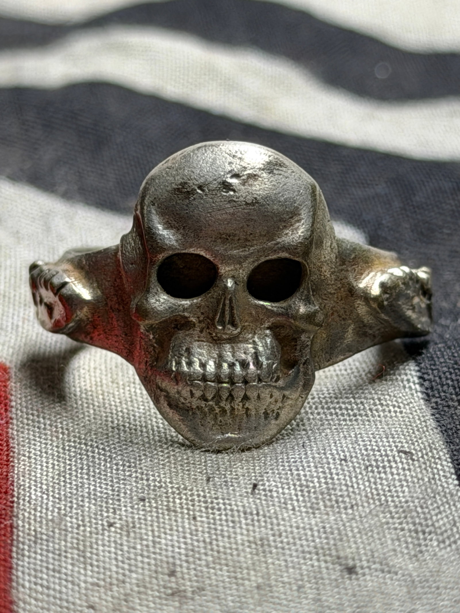 EARLY WW2 GERMAN TOTENKOPF SS SKULL RING IN 800 SILVER: EARLY WW2 GERMAN TOTENKOPF SS SKULL RING IN 800 SILVER. A VERY RARE FIND THAT IS IN MINT OVERALL SHAPE AND CONDITION WITH A BEAUTIFUL OVERALL PATINA. SHOWS GOOD WEAR AND USE. PLEASE VIEW ALL DETAILED 