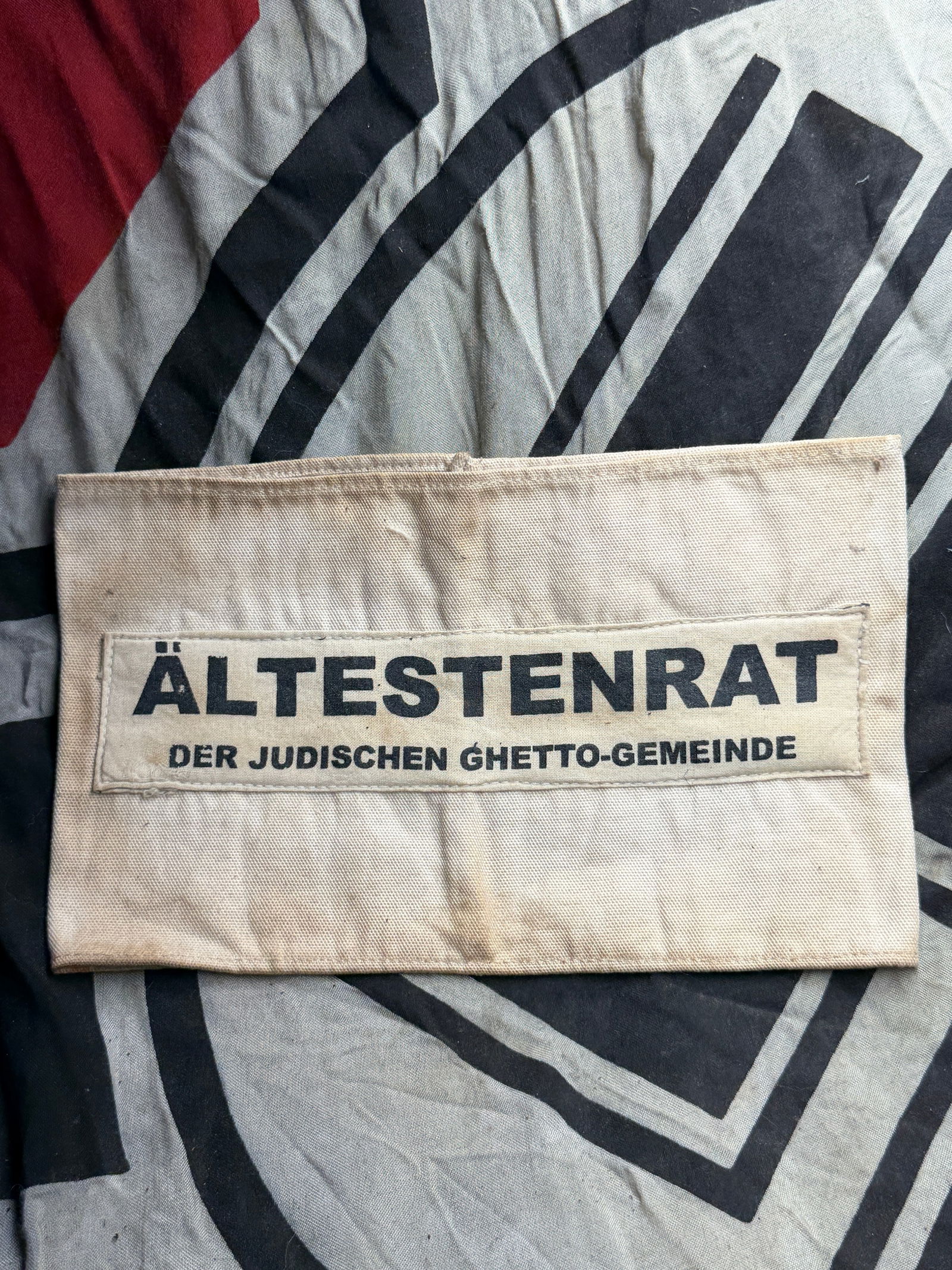 WW2 GERMAN ALTESTENRAT DER JUDISCHEN GHETTO ARMBAND 1940s: WW2 GERMAN ALTESTENRAT DER JUDISCHEN GHETTO ARMBAND 1940s. This fabric armband bears the printed text “Ältestenrat der jüdischen Ghetto-Gemeinde” (“Council of Elders of the Jewish Ghetto C